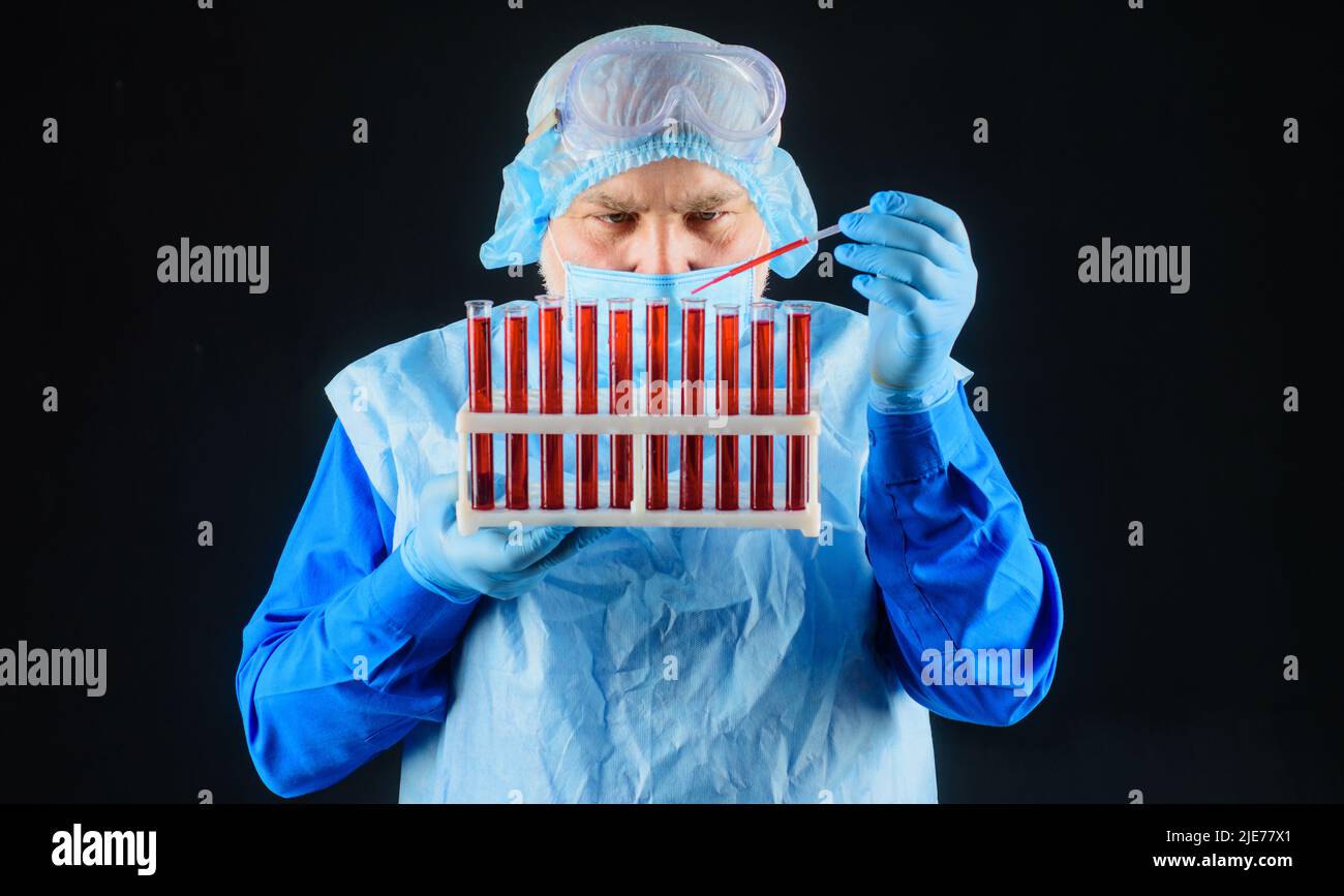 Laboratory Research Lab Technician In Medical Uniform Analyzing Blood Sample In Test Tubes laboratory-research-lab-technician-in-medical-uniform-analyzing-blood-sample-in-test-tubes