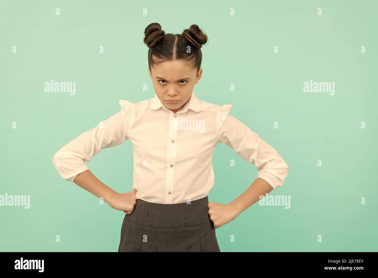 Disobedient girl child back to school standing with arms akimbo blue ...