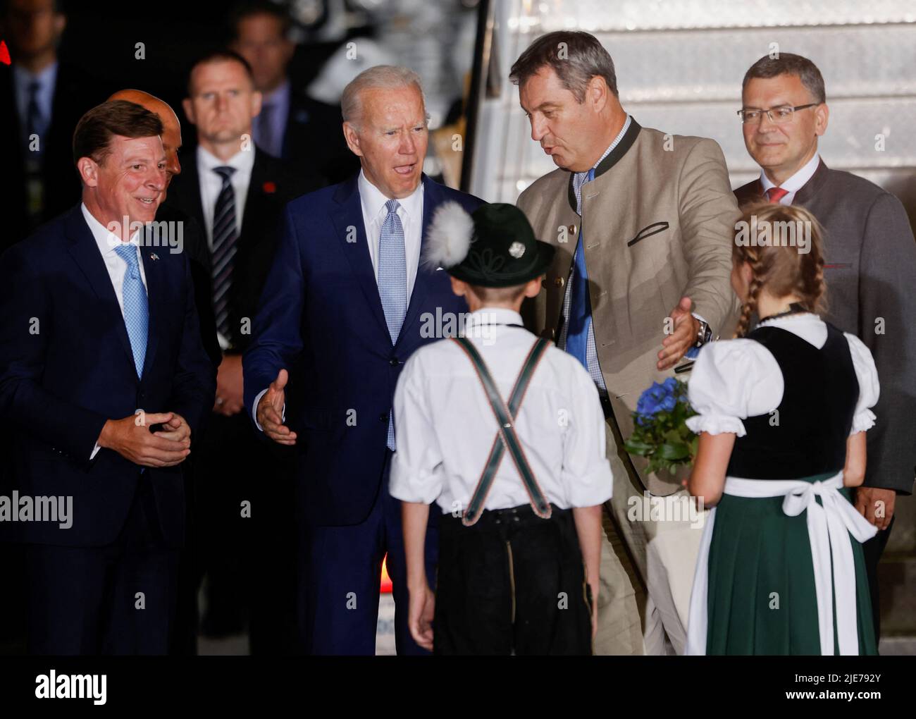 Children in traditional Bavarian clothes welcome U.S. President Joe Biden as he arrives for a G7 summit at Munich International Airport near Munich, Germany June 25, 2022. REUTERS/Michaela Rehle Stock Photo