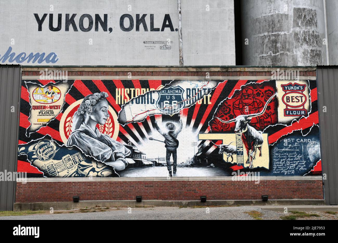 A mural commemorating the Route 66 city of Yukon, Oklahoma, graces the base of the historic Yukon Mill & Grain Company elevators. Stock Photo
