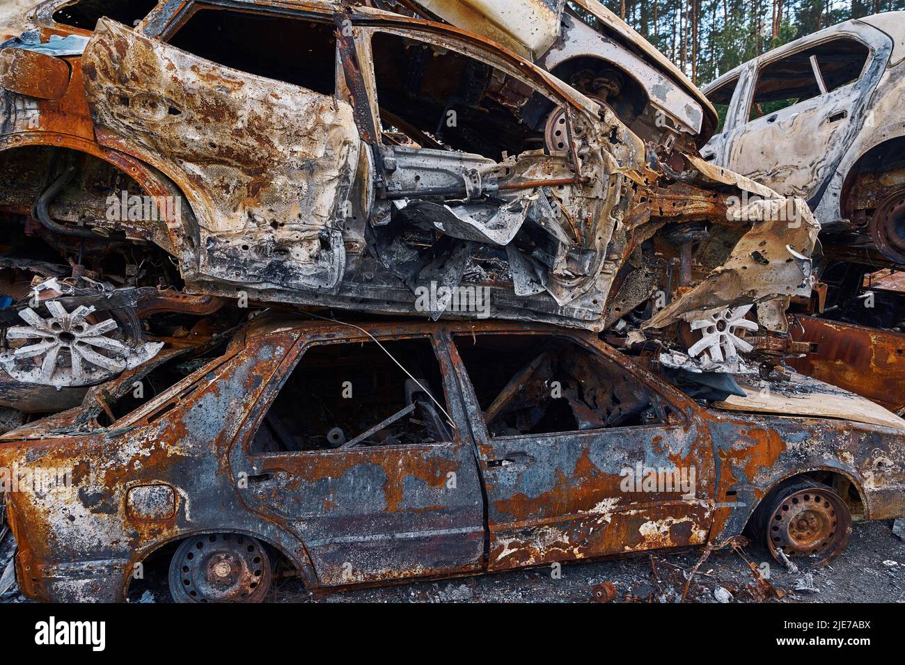 Old Car Riddled Bullets Bullet-ridden and shelled automobiles on top of one another Stock Photo ...