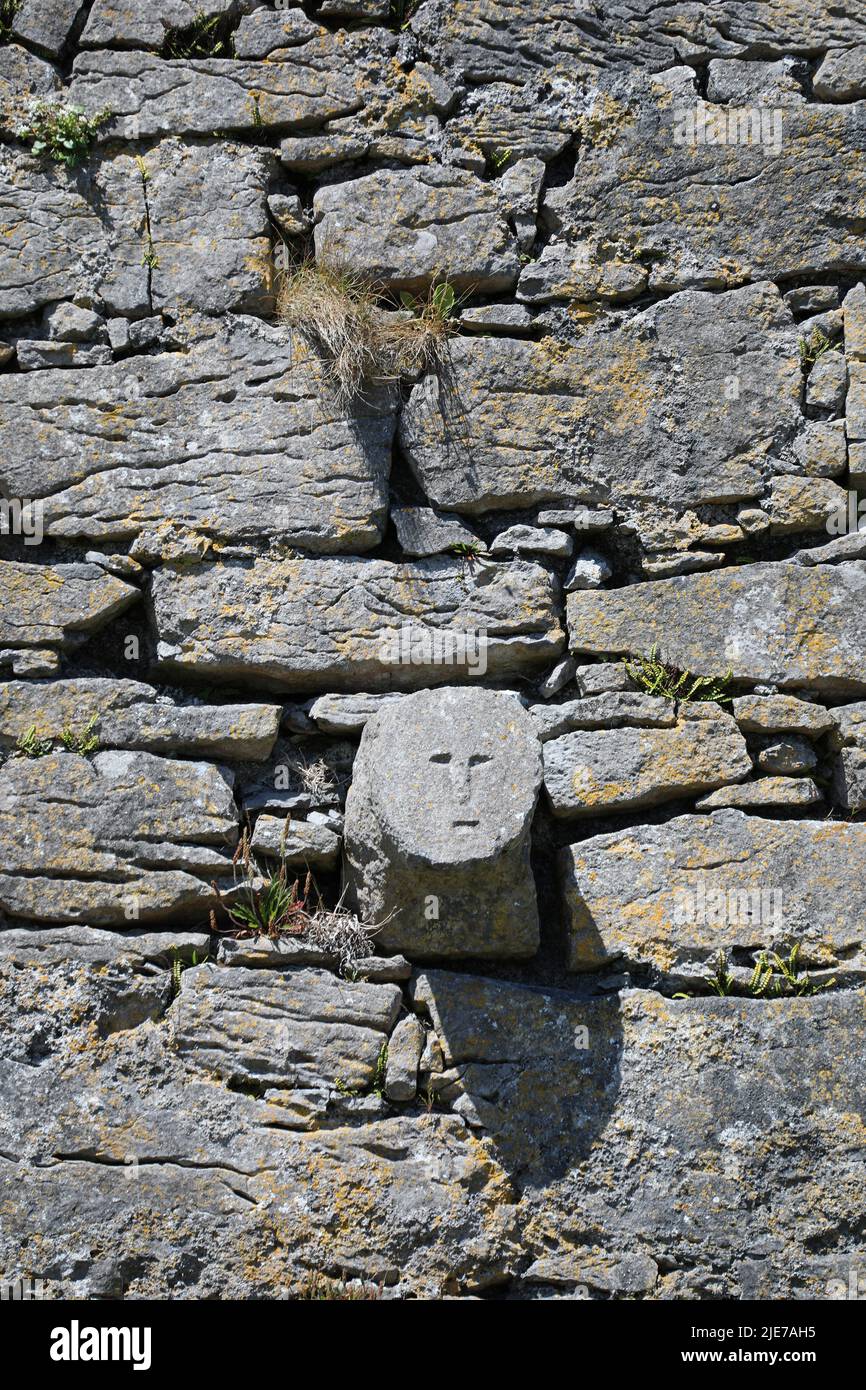 Carved face at Furmina Castle on Inisheer in the Republic of Ireland Stock Photo