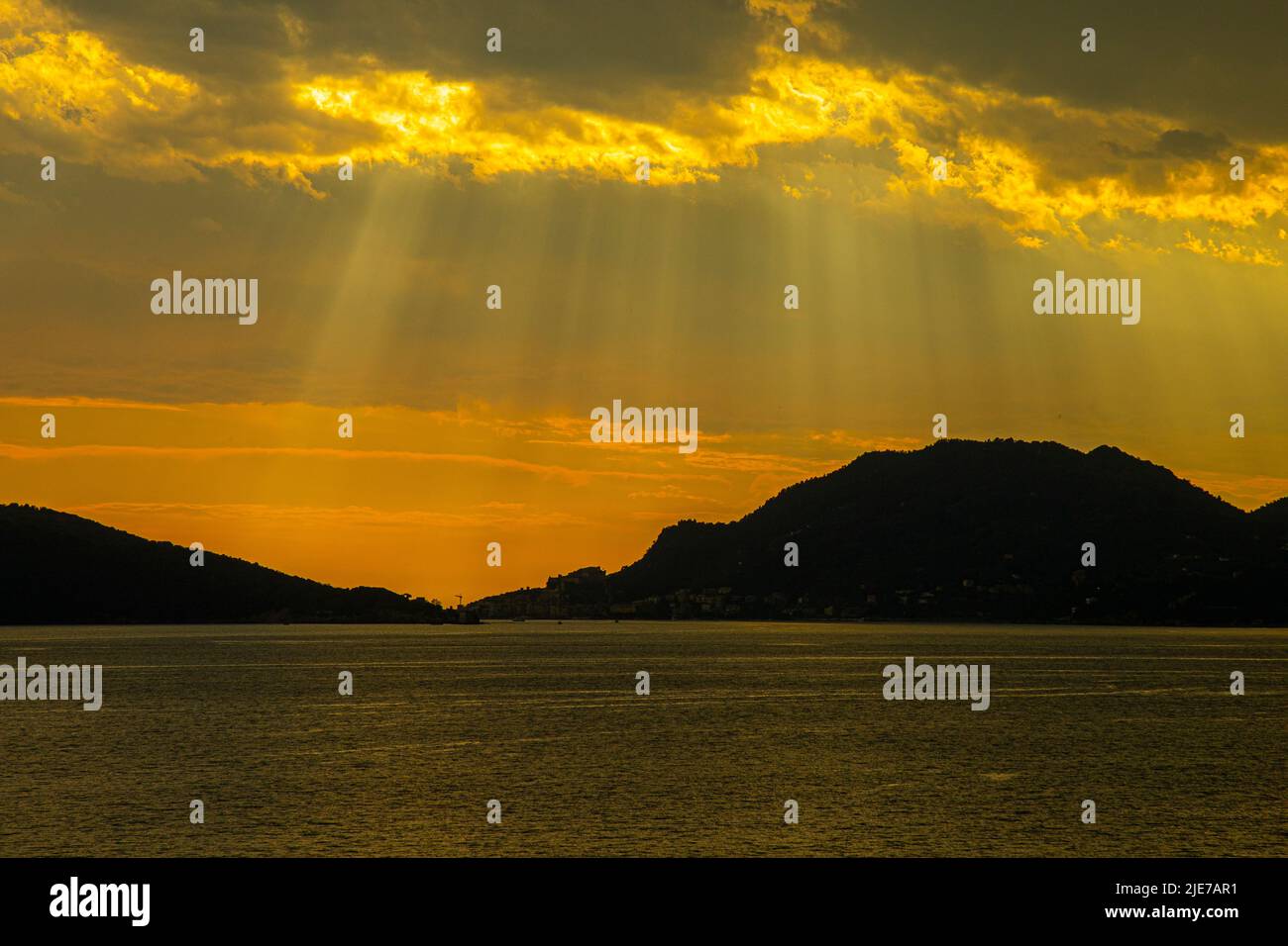 stormy sky over the sea , the rays of the sun break through the clouds Stock Photo