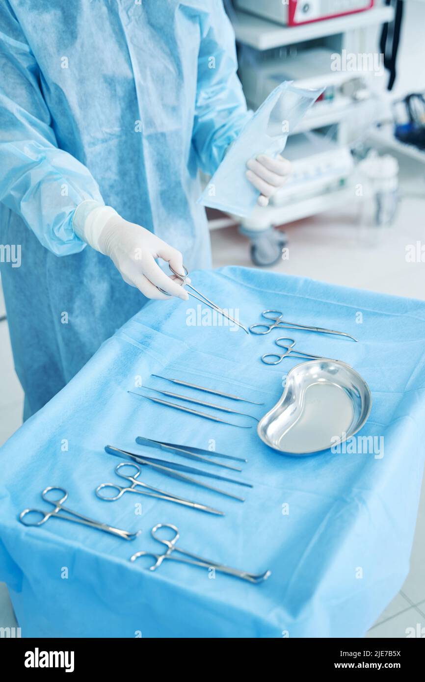 Doctor holding medical clamps hi-res stock photography and images - Alamy