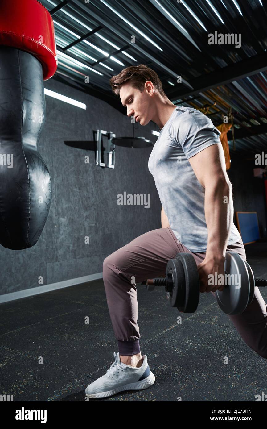 Brawny guy doing leg workout at gym Stock Photo Alamy