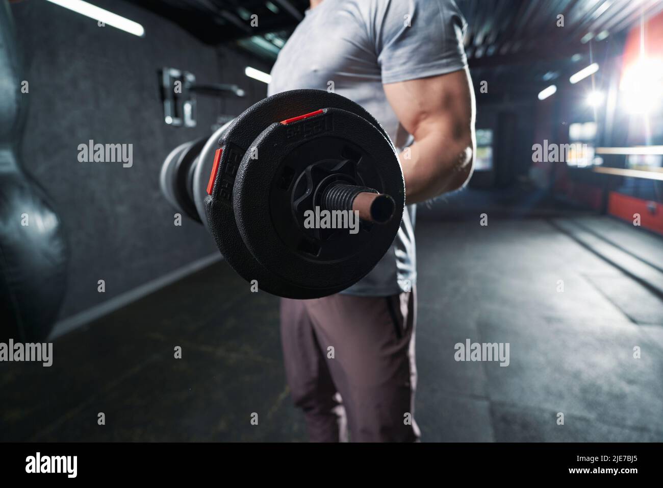 sportsman-performing-strength-training-exercise-with-hand-weights-stock