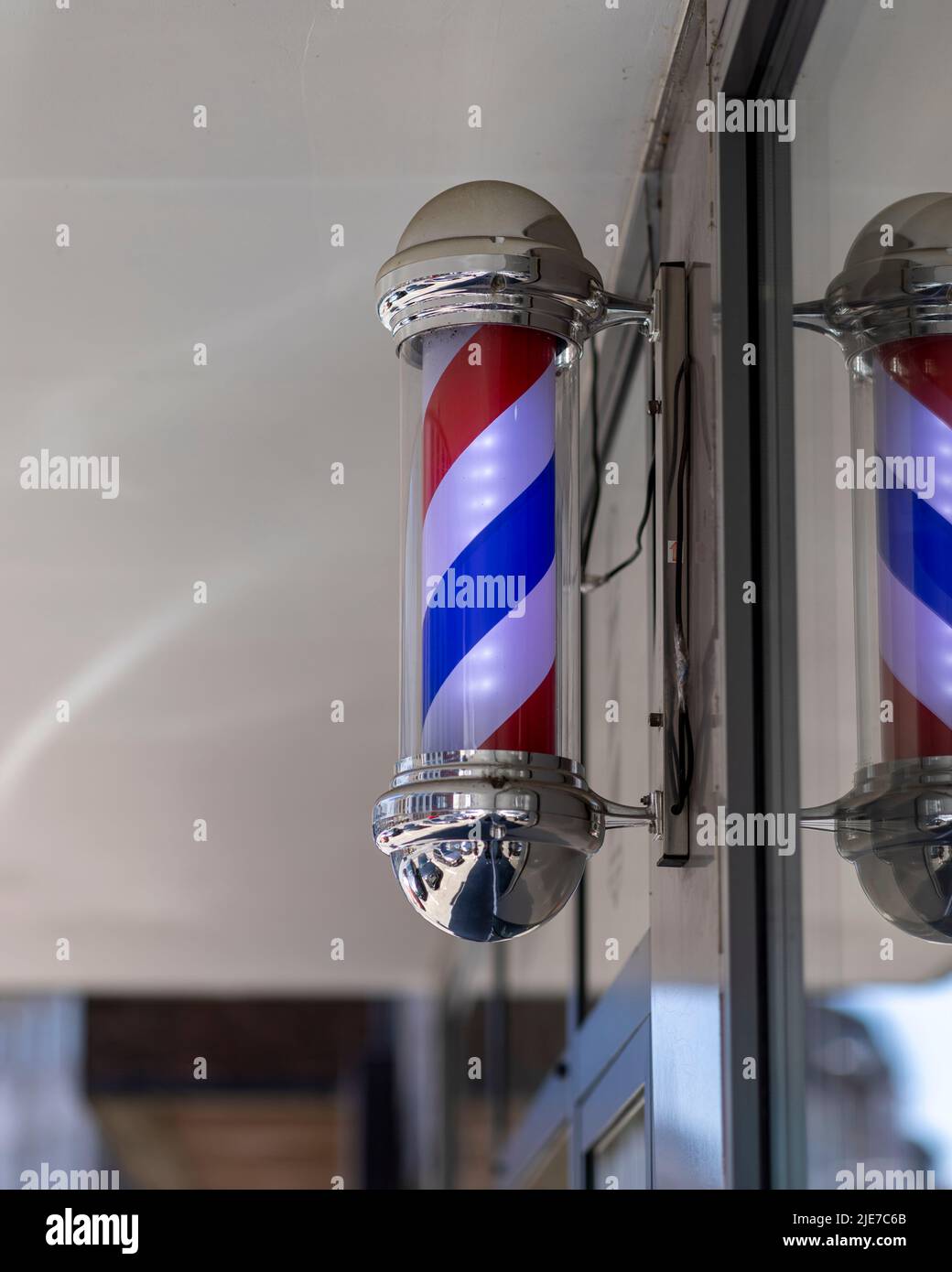 A Barber's Pole in front of barbers shop in Cologne Stock Photo
