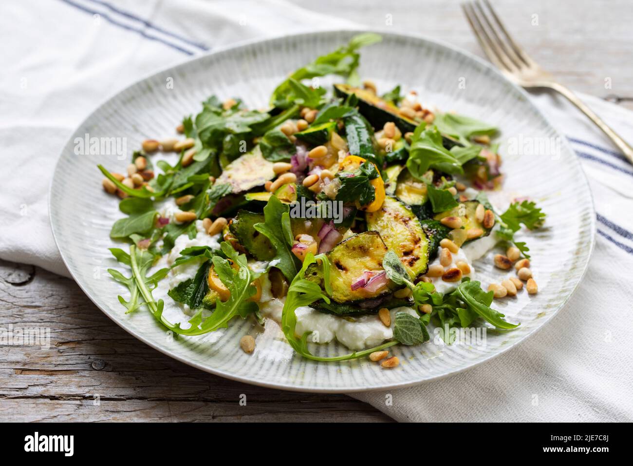 Baby courgette salad on ricotta cheese Stock Photo