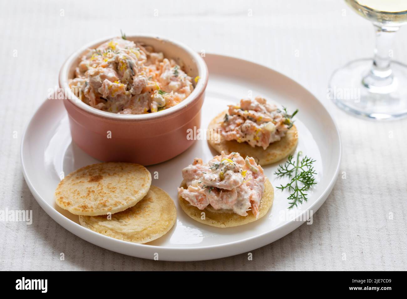 Party canapes, blinis with salmon spread Stock Photo