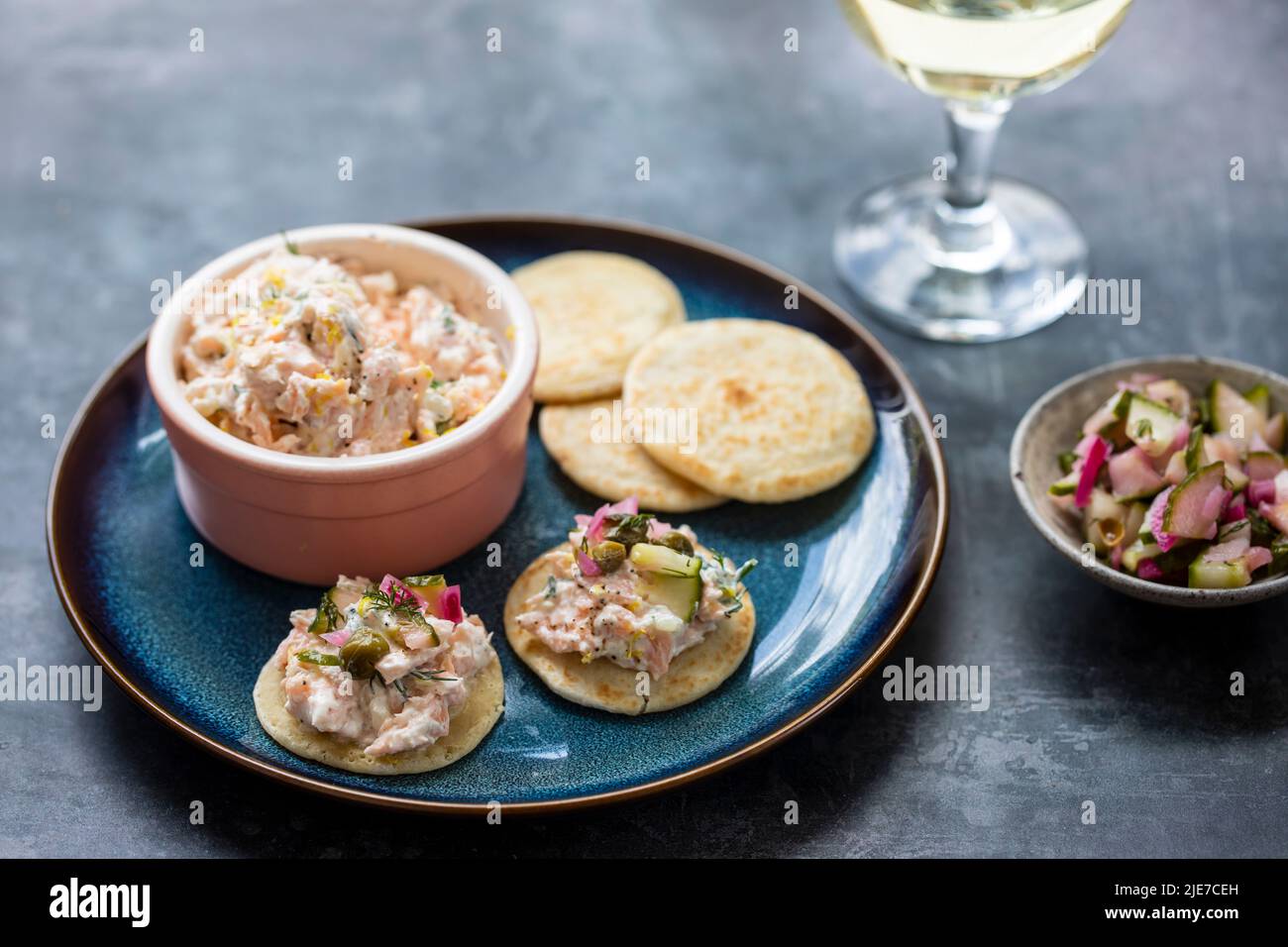 Party canapes, blinis with salmon spread Stock Photo
