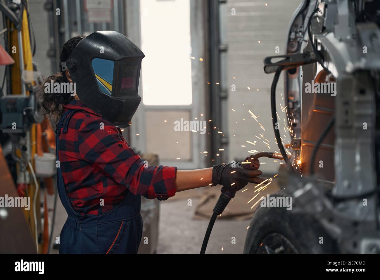 Competent car master welding auto in garage Stock Photo Alamy