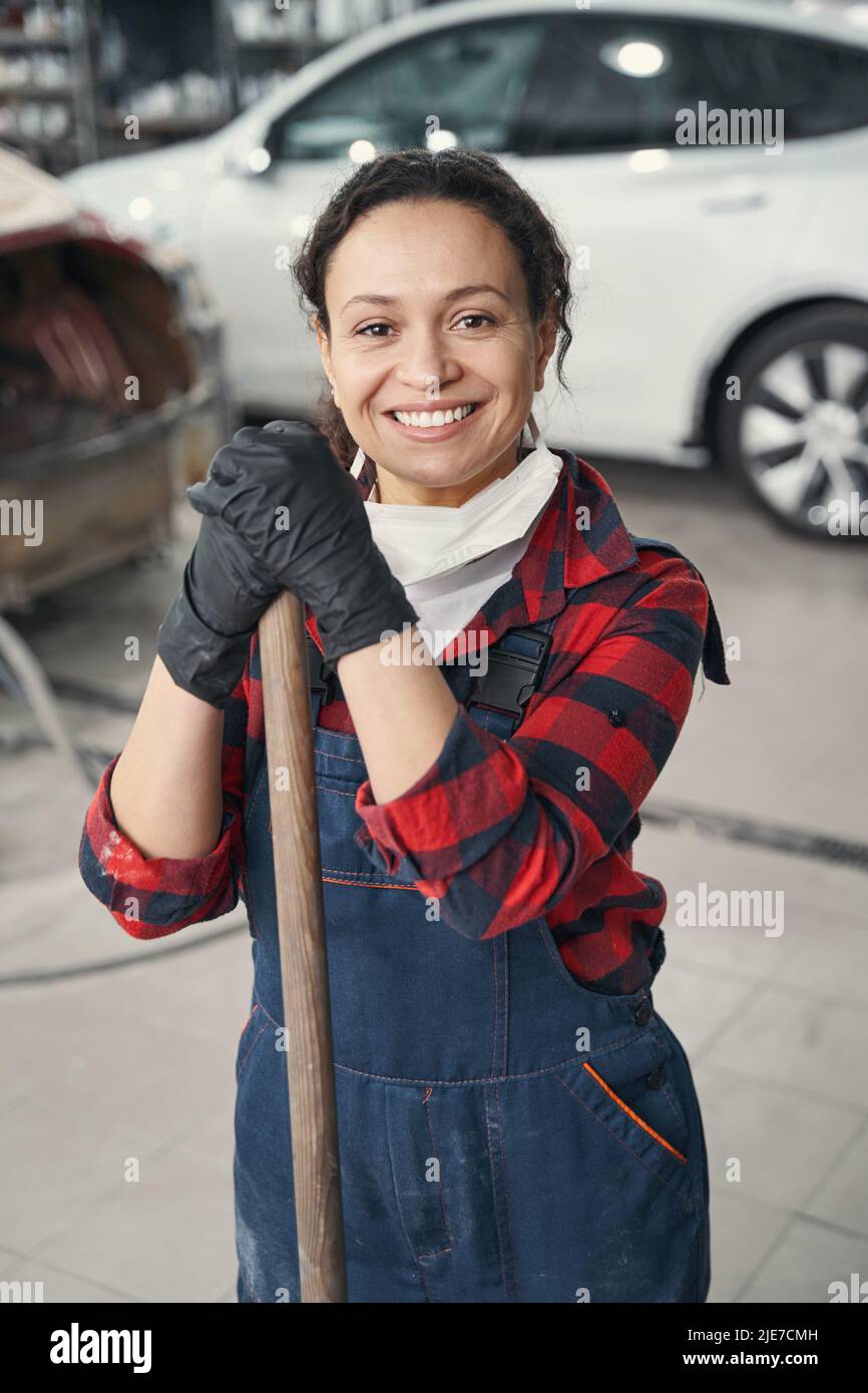 Positive delighted woman working at modern service station Stock Photo
