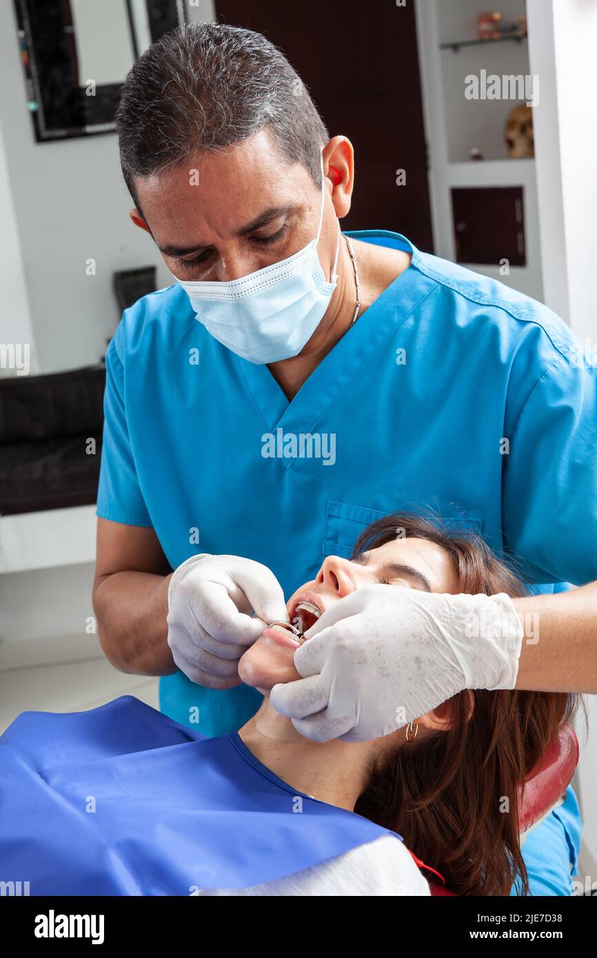 orthodontic specialist dentist treating a female patient Stock Photo