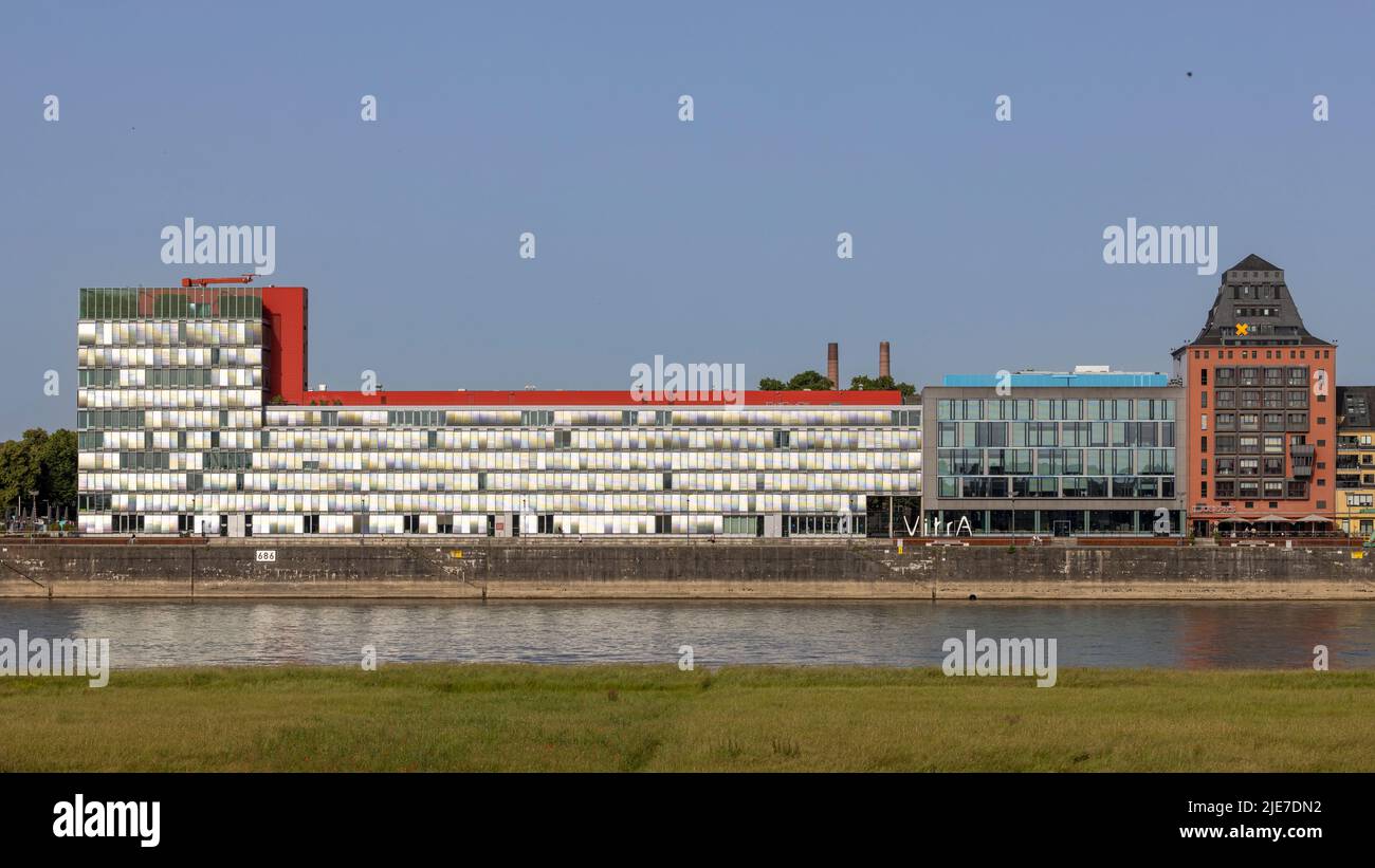 Modern office building standing on riverbanks of Rhine river in Cologne Stock Photo