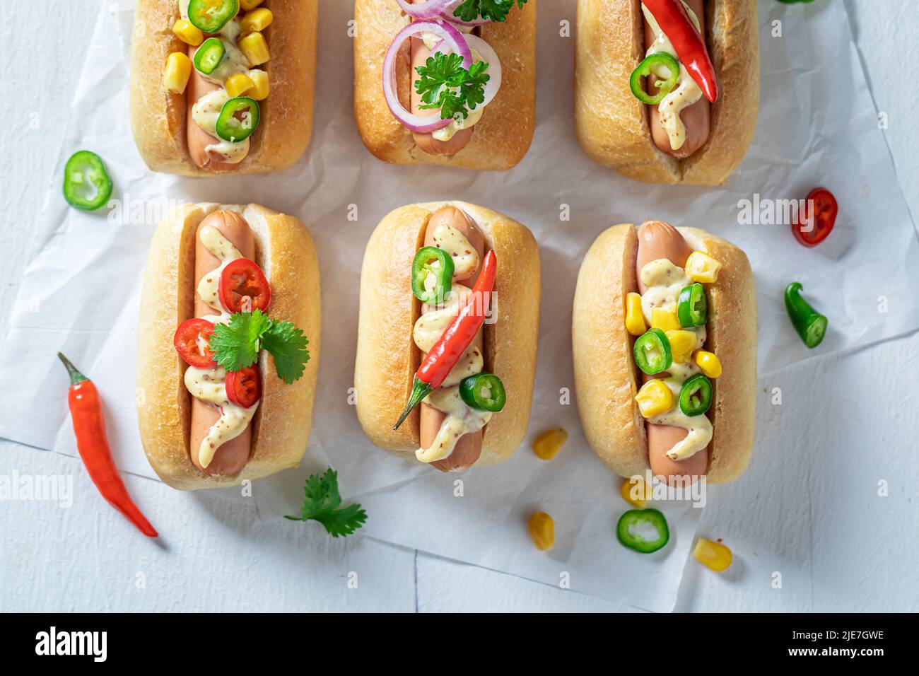 Unhealthy and tasty mini hot dogs with various toppings. Mini hot dogs ...
