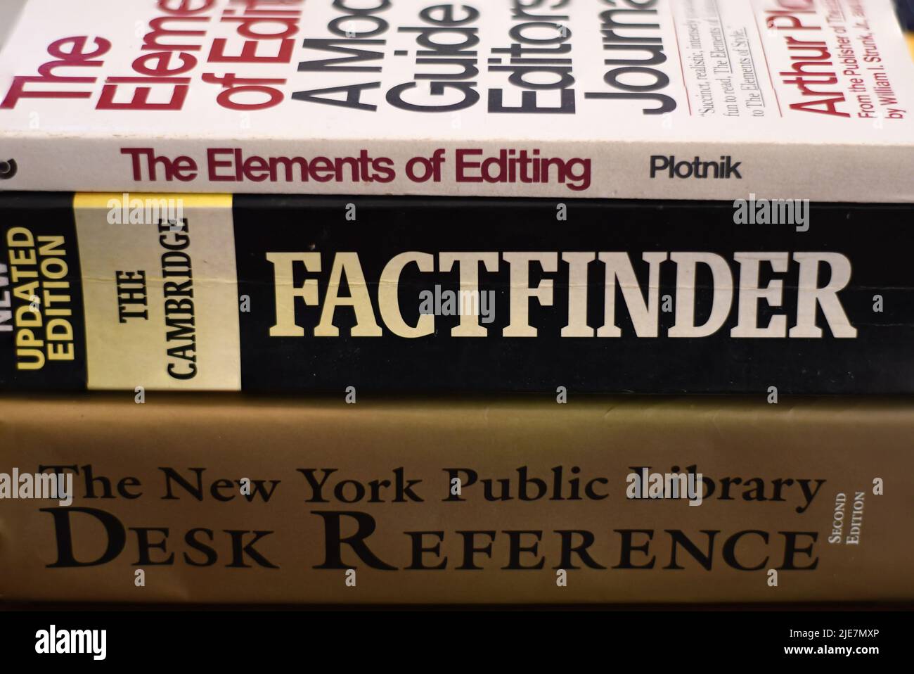 Side view of a pile of knowledgeable books on a table Stock Photo