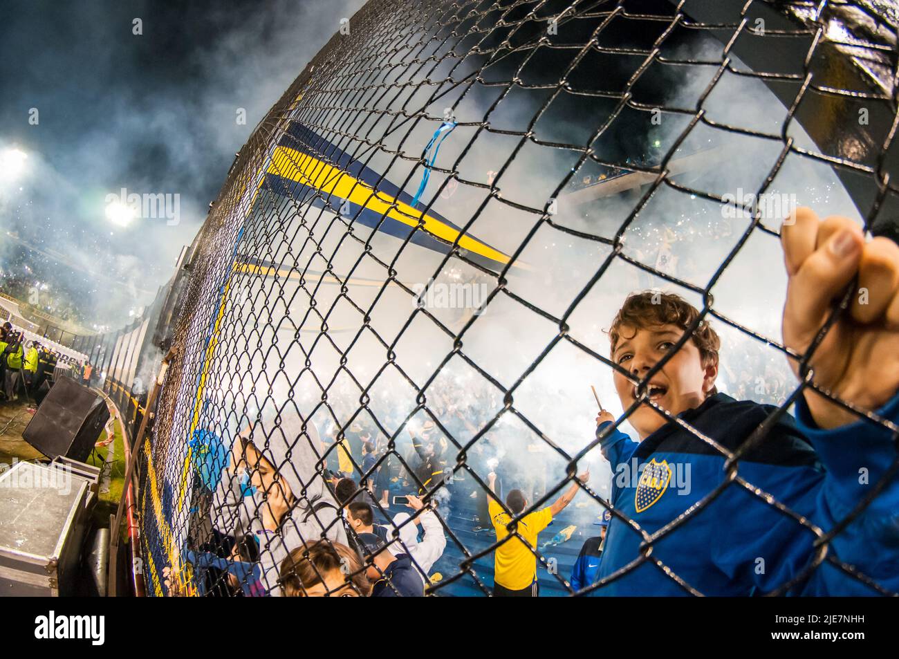 Boy holding stick of fireworks to receive the home team Boca Juniors at La Bombonera Stadium. Stock Photo
