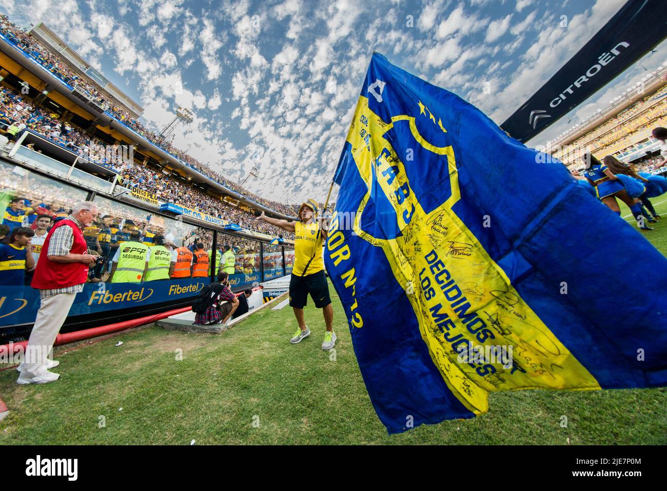 A local crew member ignites the crowd before the home team, Boca Juniors, enters the field at La Bombonera Stadium. Stock Photo