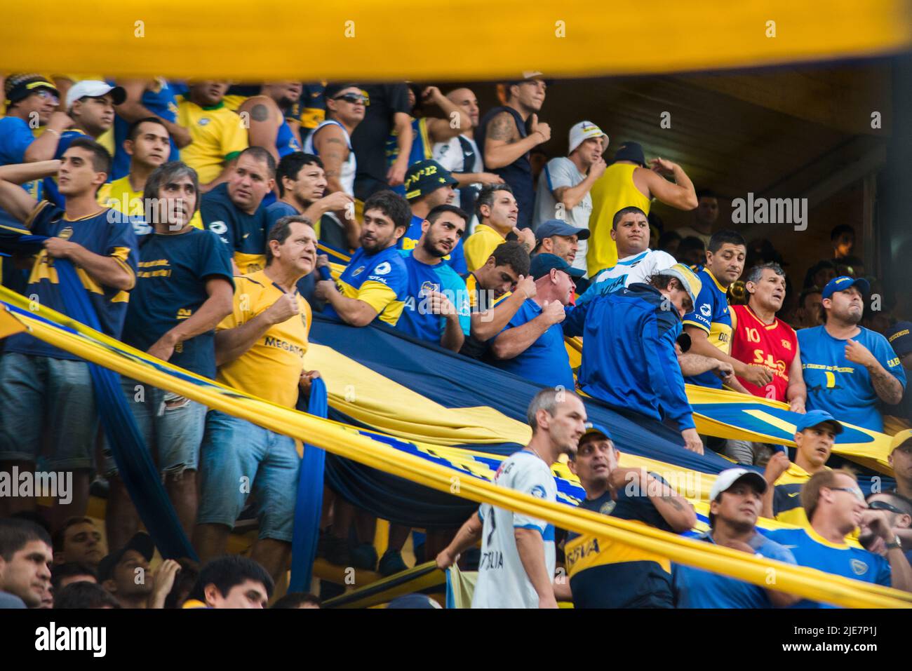 Fans support the home team Boca Juniors with songs at La Bombonera Stadium. Stock Photo