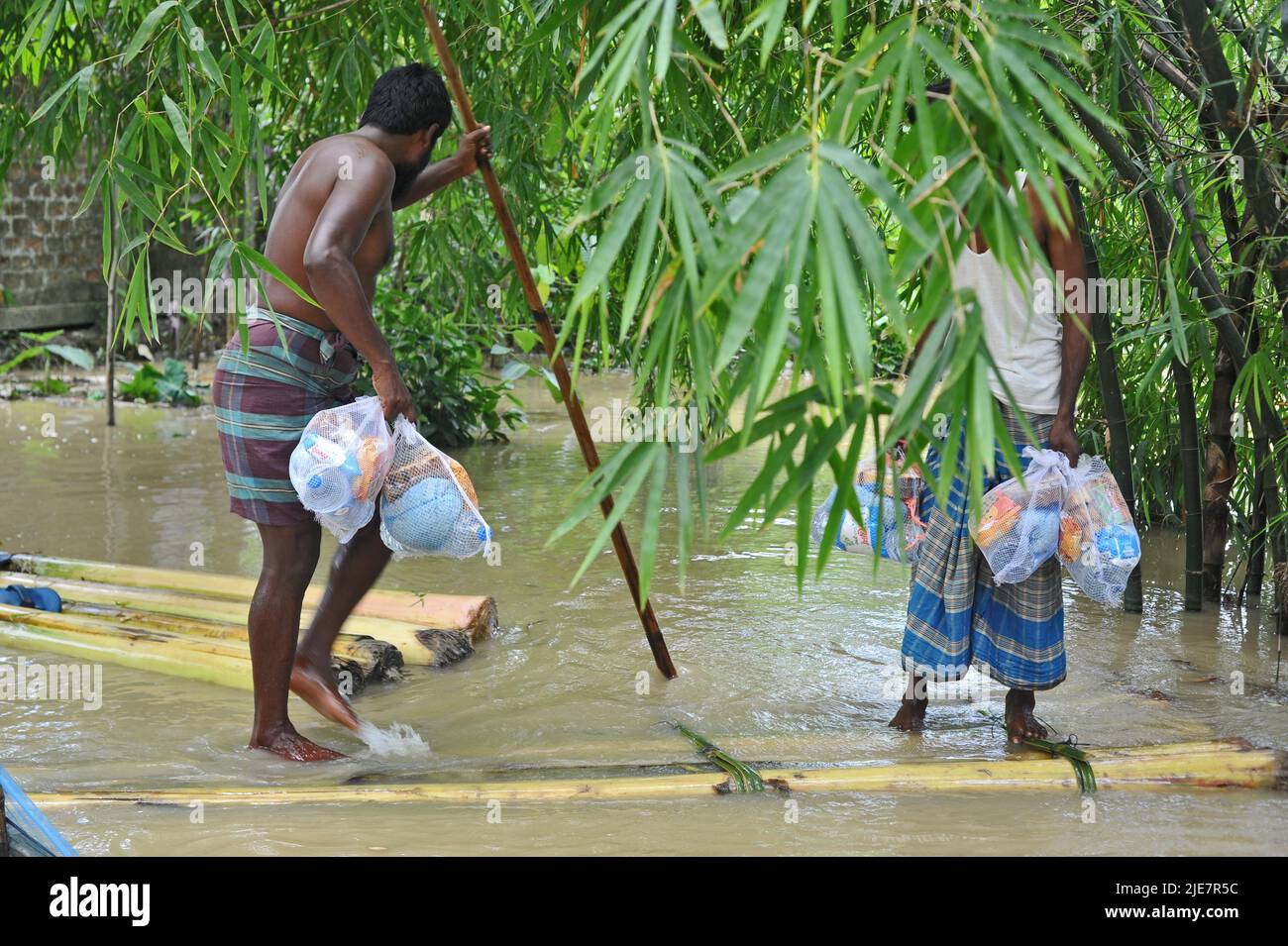 Sylhet, Mexico City, Bangladesh. 25th June, 2022. June 25, 2022, Sylhet, Bangladesh: Rural people receive the Relief on raf by the flood in the Badeswar area, The flood situation in some parts of Sylhet has worsened, with high water levels in the Kushiara River rising in the past 48 hours. According to the local office of the Bangladesh Water Development Board, the Kushiara was flowing above the danger level at various points. on June 25, 2022 in Sylhet, Bangladesh. (Credit Image: © Md Rafayat Haque Khan/eyepix via ZUMA Press Wire) Stock Photo