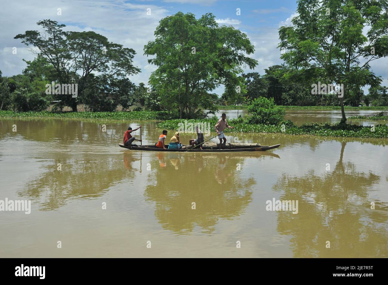 Sylhet, Mexico City, Bangladesh. 25th June, 2022. June 25, 2022, Sylhet, Bangladesh: Rural people transporting on a boats by the flood in the Badeswar area, The flood situation in some parts of Sylhet has worsened, with high water levels in the Kushiara River rising in the past 48 hours. According to the local office of the Bangladesh Water Development Board, the Kushiara was flowing above the danger level at various points. on June 25, 2022 in Sylhet, Bangladesh. (Credit Image: © Md Rafayat Haque Khan/eyepix via ZUMA Press Wire) Stock Photo