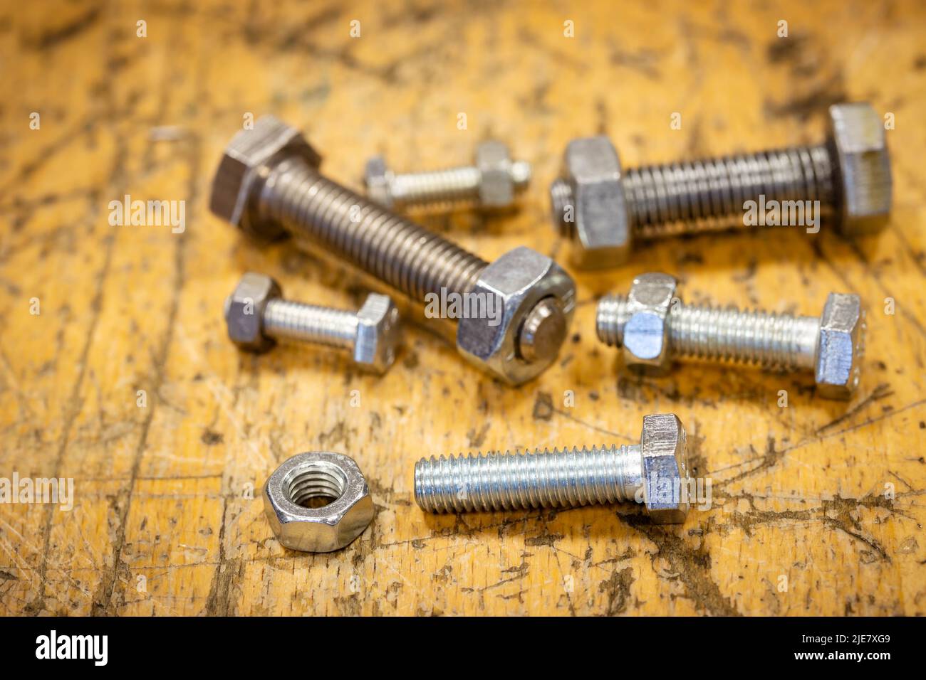 set of screws of different sizes on a wooden workbench Stock Photo
