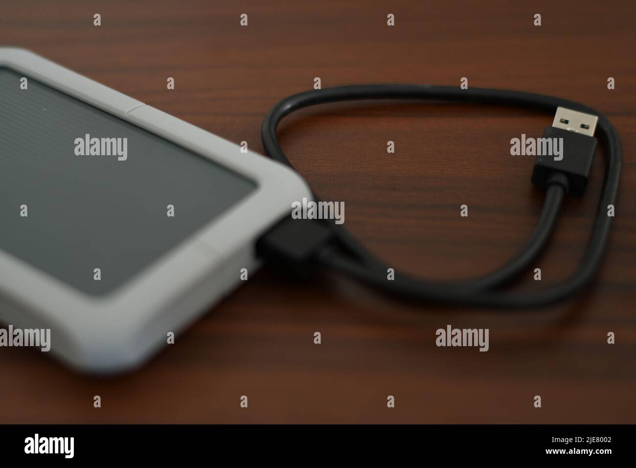 Portable HDD with its cable on a table Stock Photo