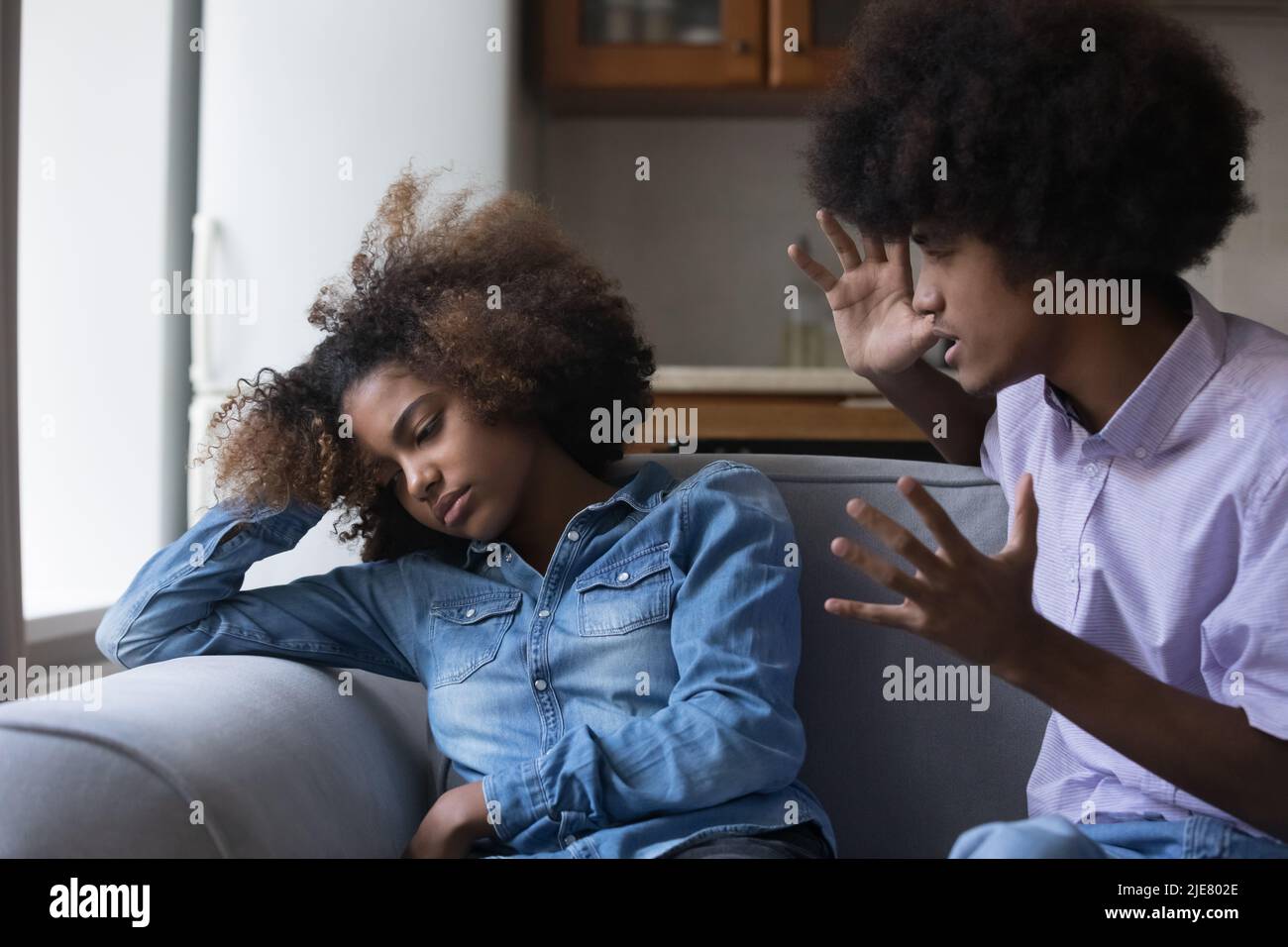 Mad African guy screams at girlfriend during quarrelling Stock Photo