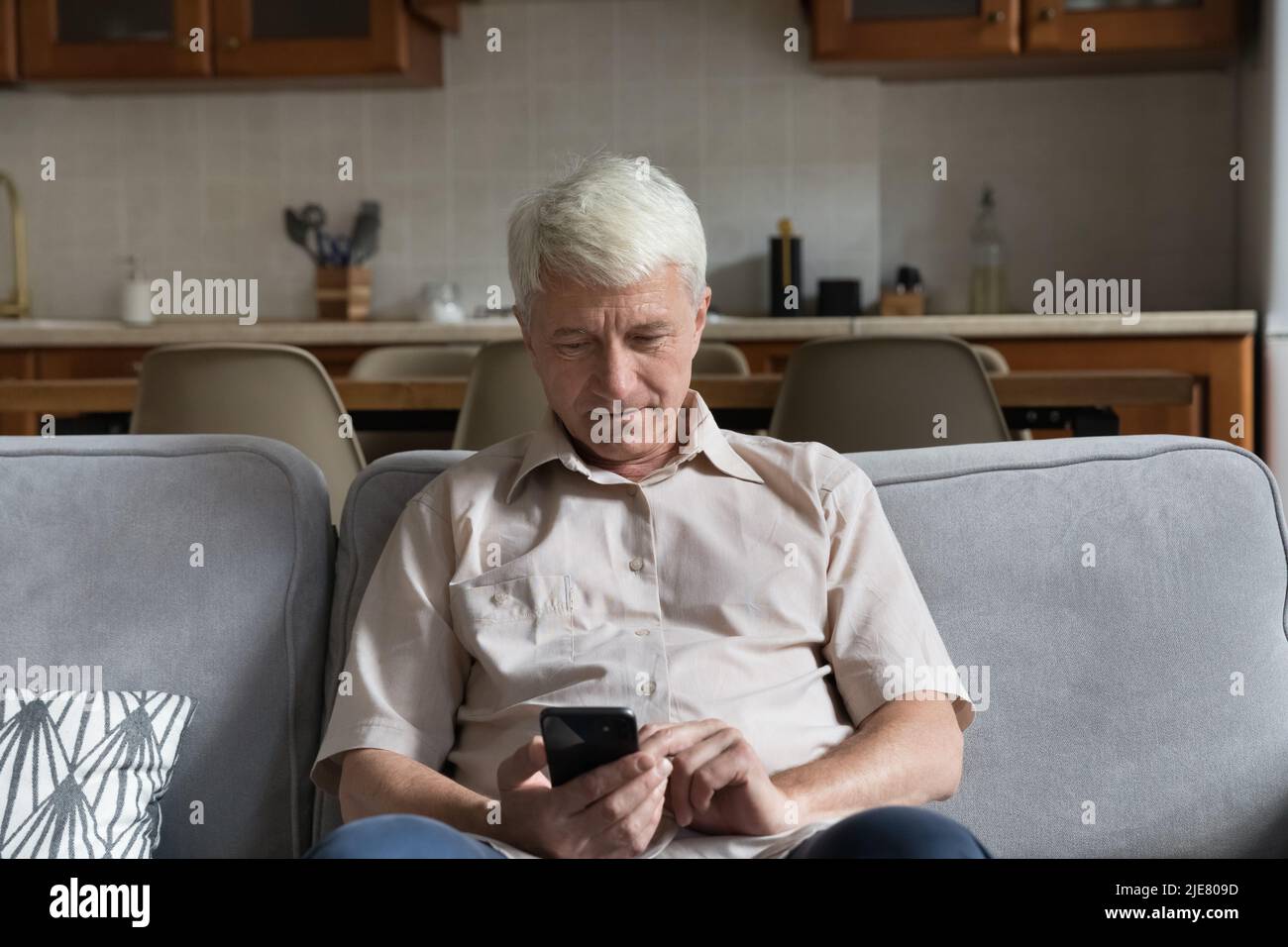 Retired man using smartphone device hi-res stock photography and images ...