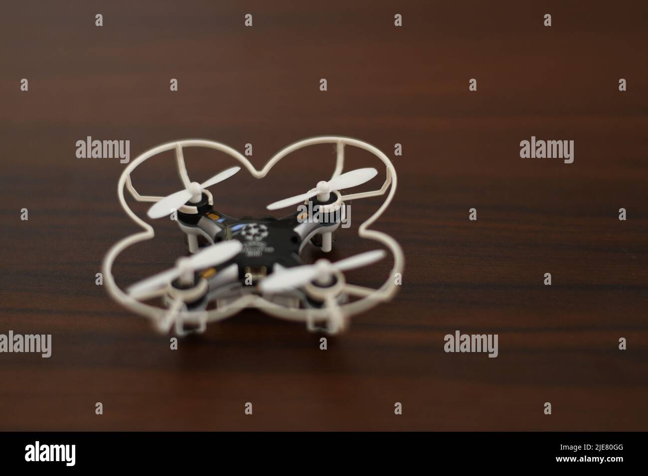 Tiny quadcopter on a wooden table Stock Photo