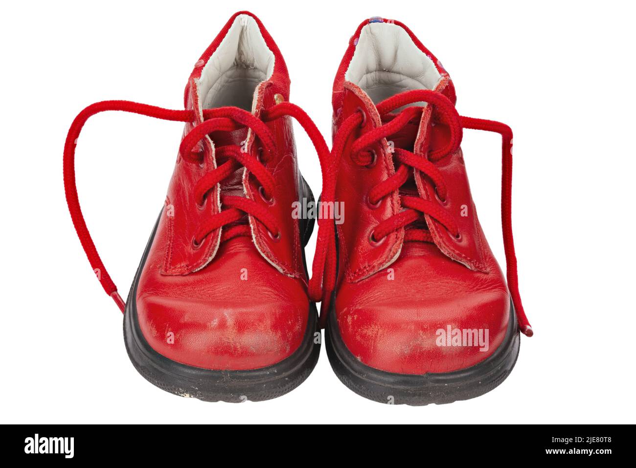 Children's shoes of red color isolated on white background. Old shoes ...