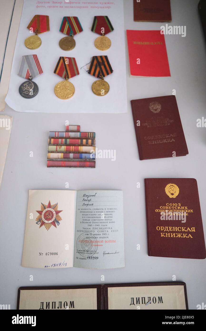 Various Soviet, USSR era medals, identification cards for the military. At the Museum of History and Local Lore in Namangan, Fergana Valley, Uzbekista Stock Photo
