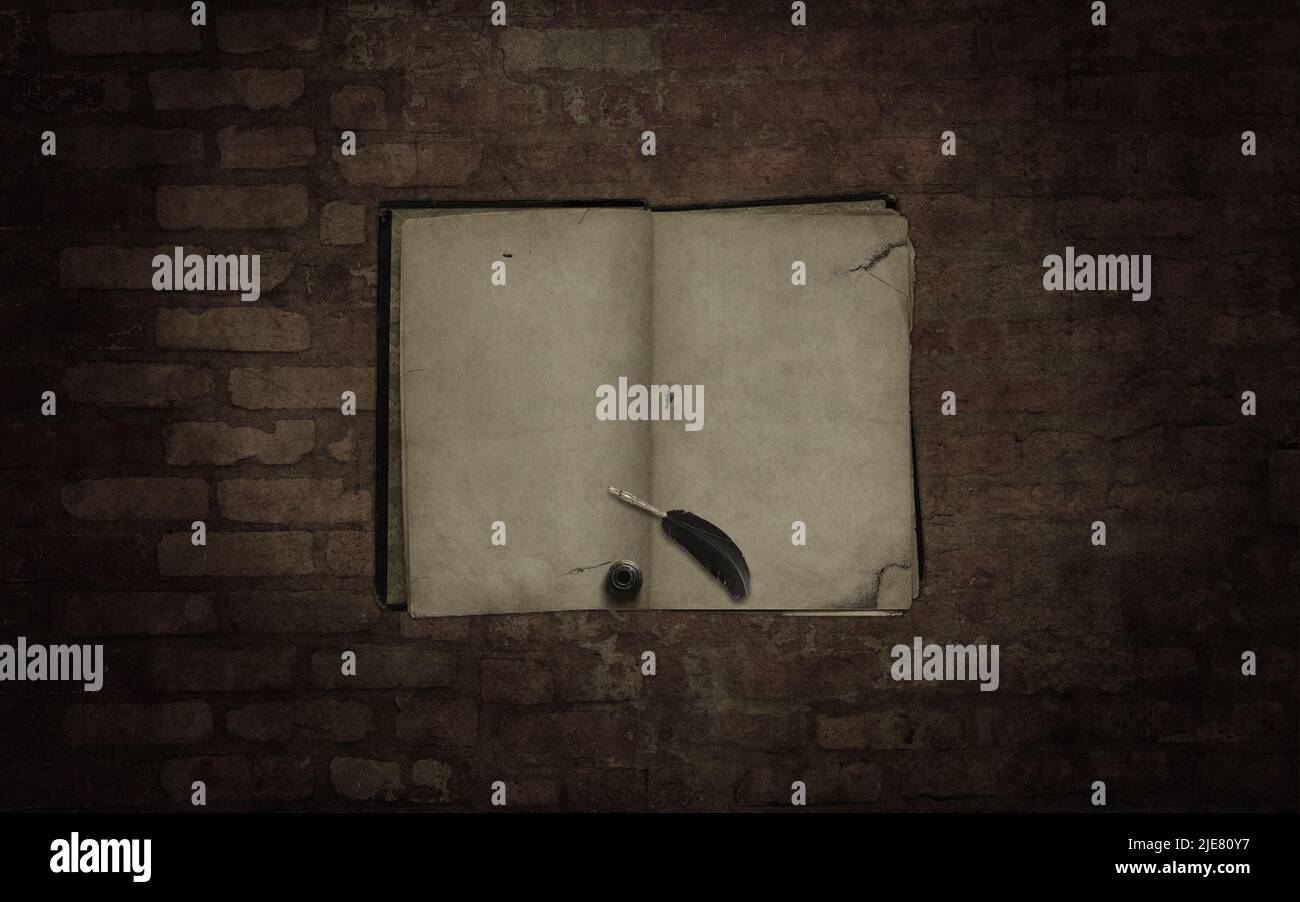 Old blanked book with feather and ink on the dark brick wall background ...