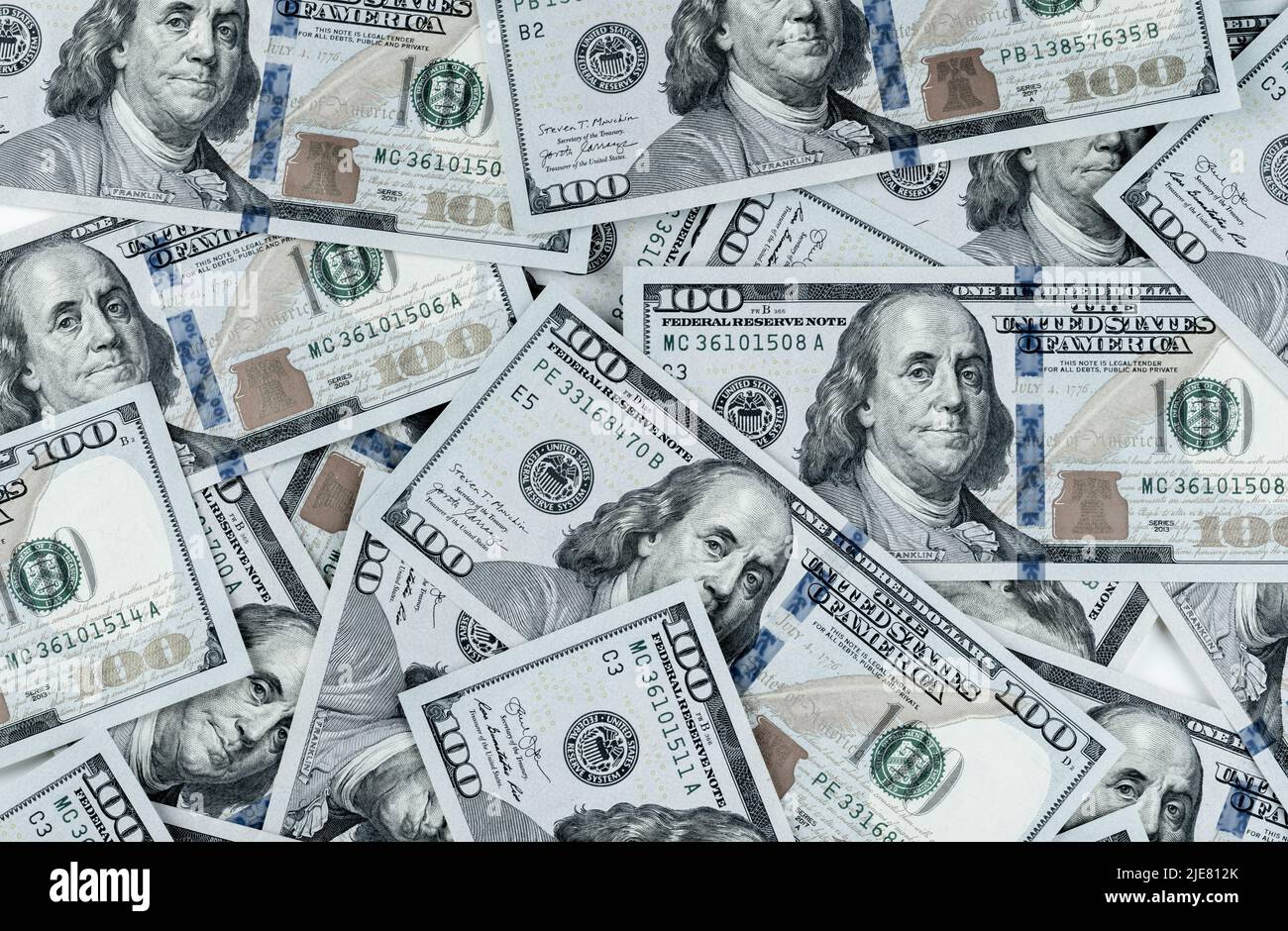 pile of one hundred US banknotes. Background with money american hundred dollar bills. 100 bills background. Lots of dollar bank notes on the table Stock Photo