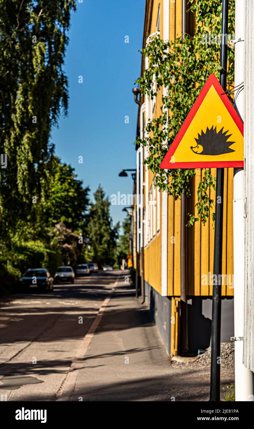 A home-made traffic sign warning about hedgehogs, in front of a wooden house in Limingantie, Kumpula, Helsinki, Finland. Stock Photo