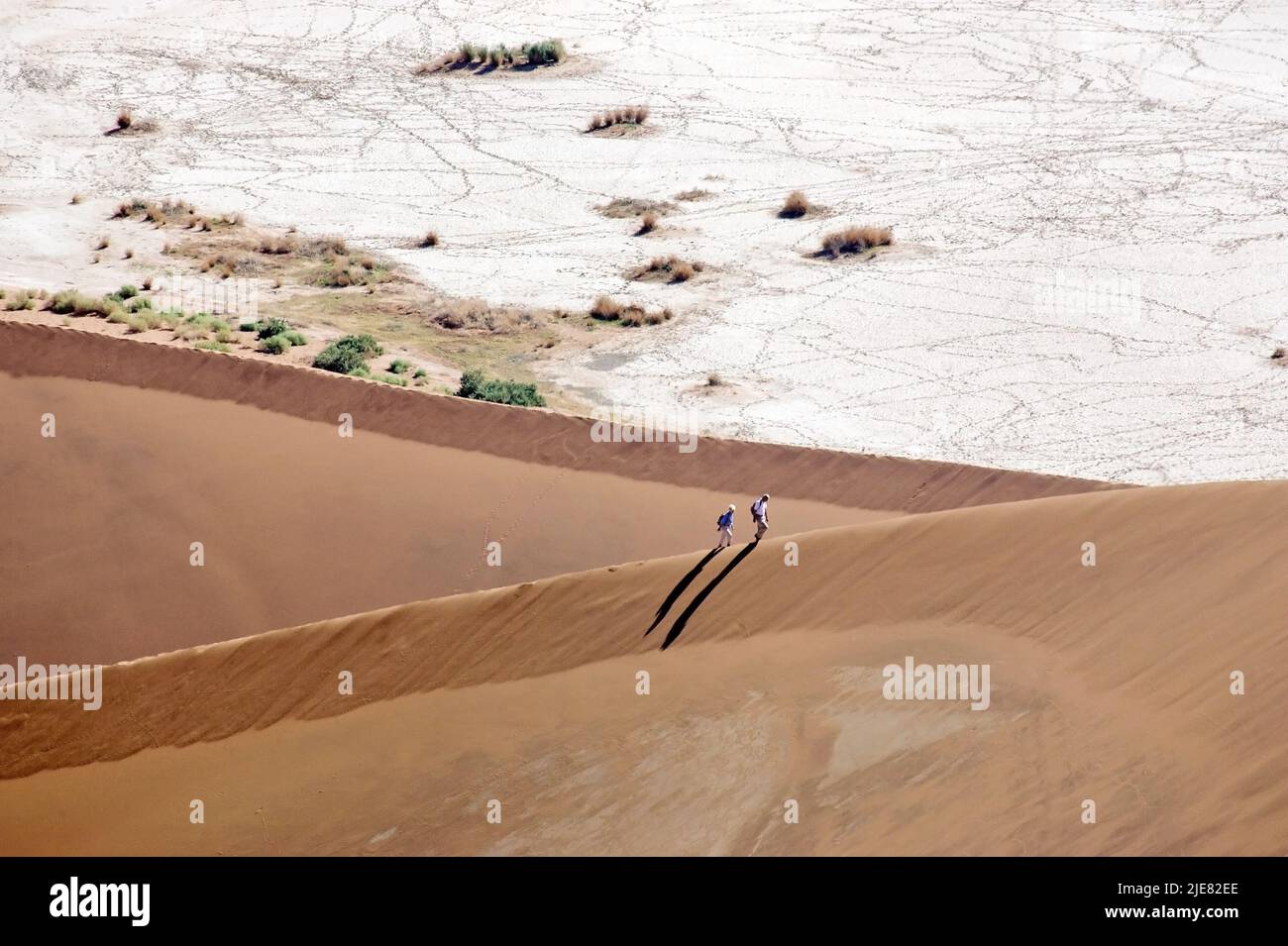 Climbing the dune in the desert Stock Photo - Alamy