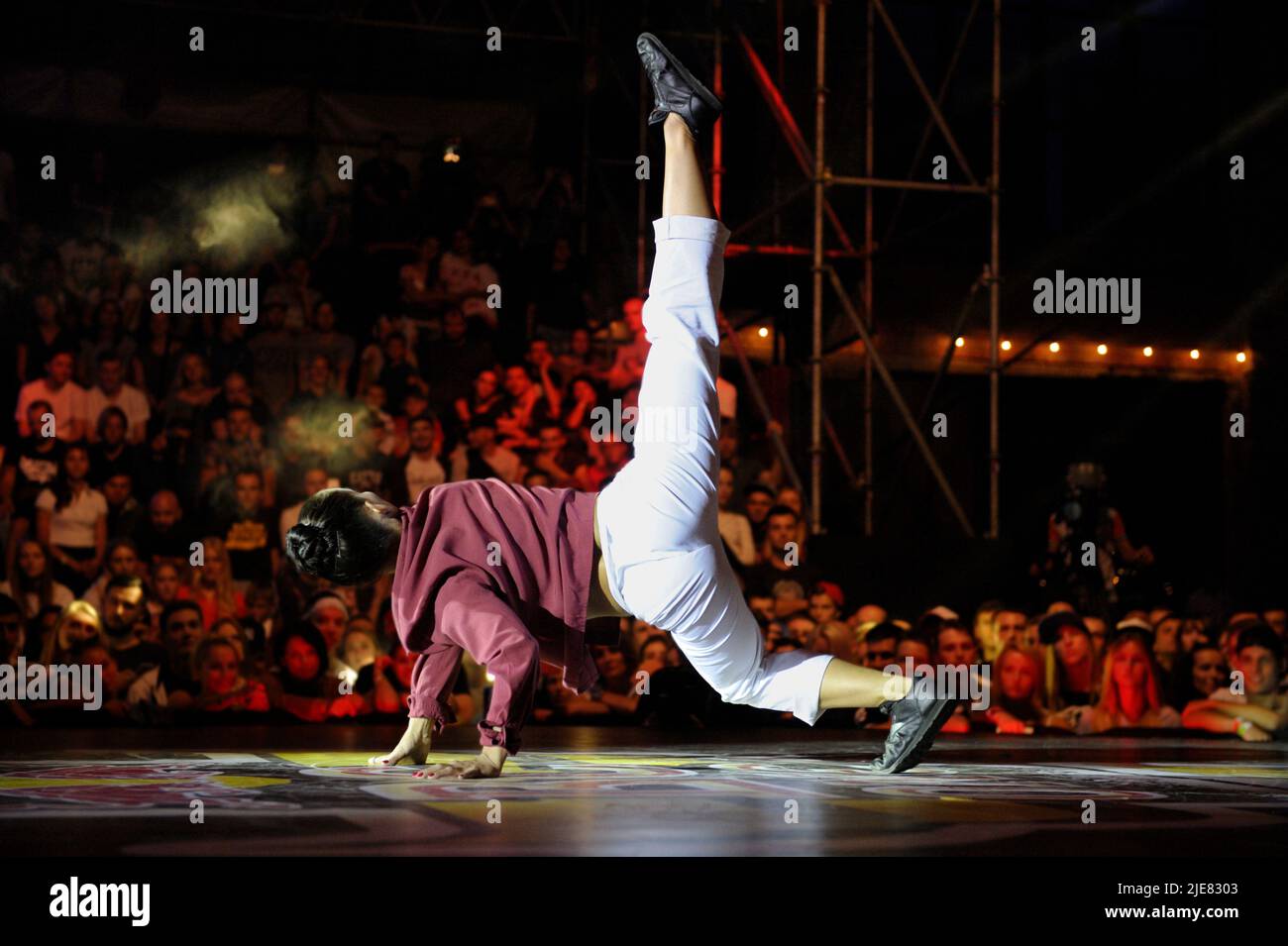 Young girl break dancer performing on stage during breakdance battle