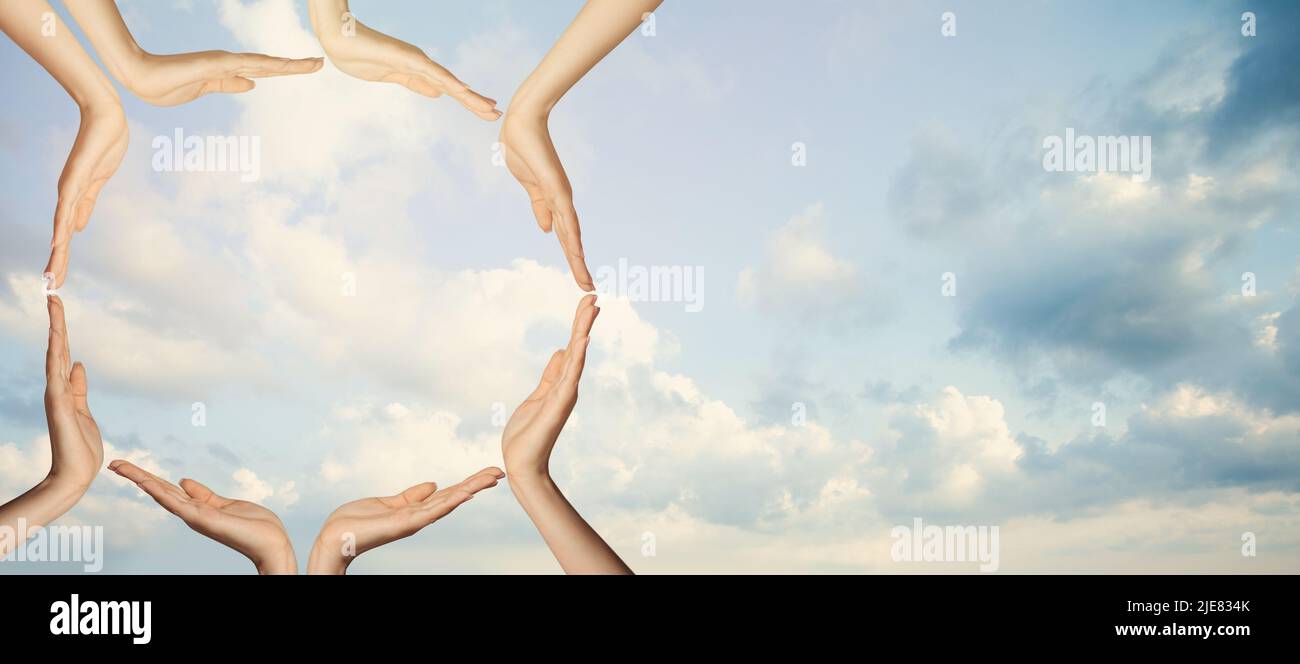 Unity concept. Hands against sky clouds background Stock Photo