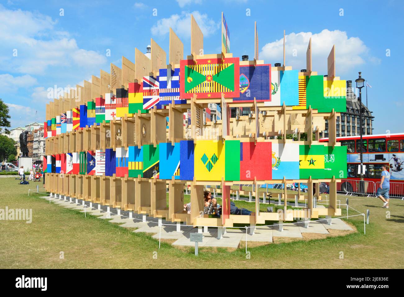Plywood & timber purpose built structure displaying graphic flags from some of 2012 Olympics competing nations in Parliament Square London England UK Stock Photo