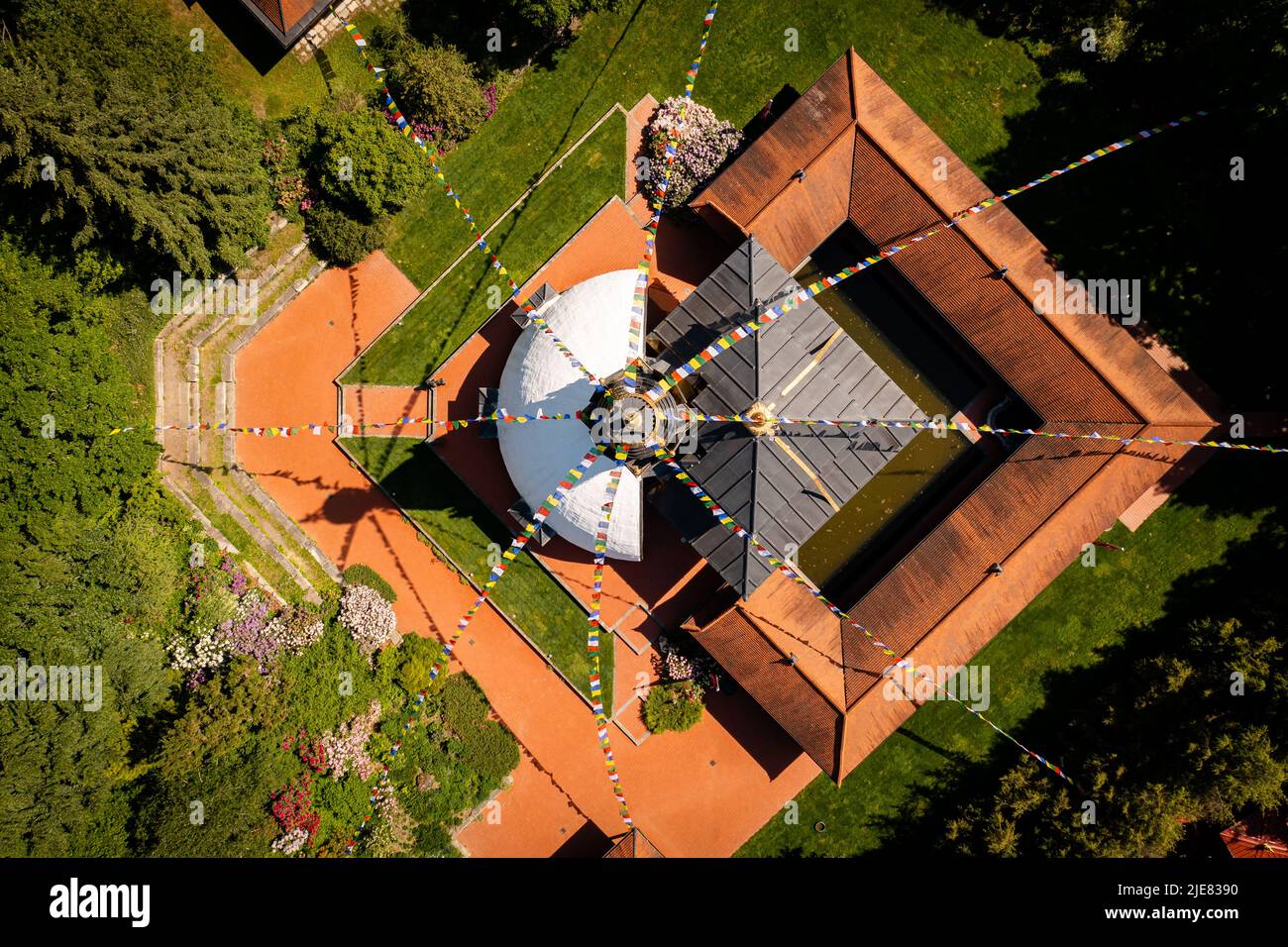 Aerial photo about Nepal Tibet pavilion in Germany. Spiritual temple tower with hanging flags. Time for meditation and thoughts in the Nepal Himalaya. Stock Photo