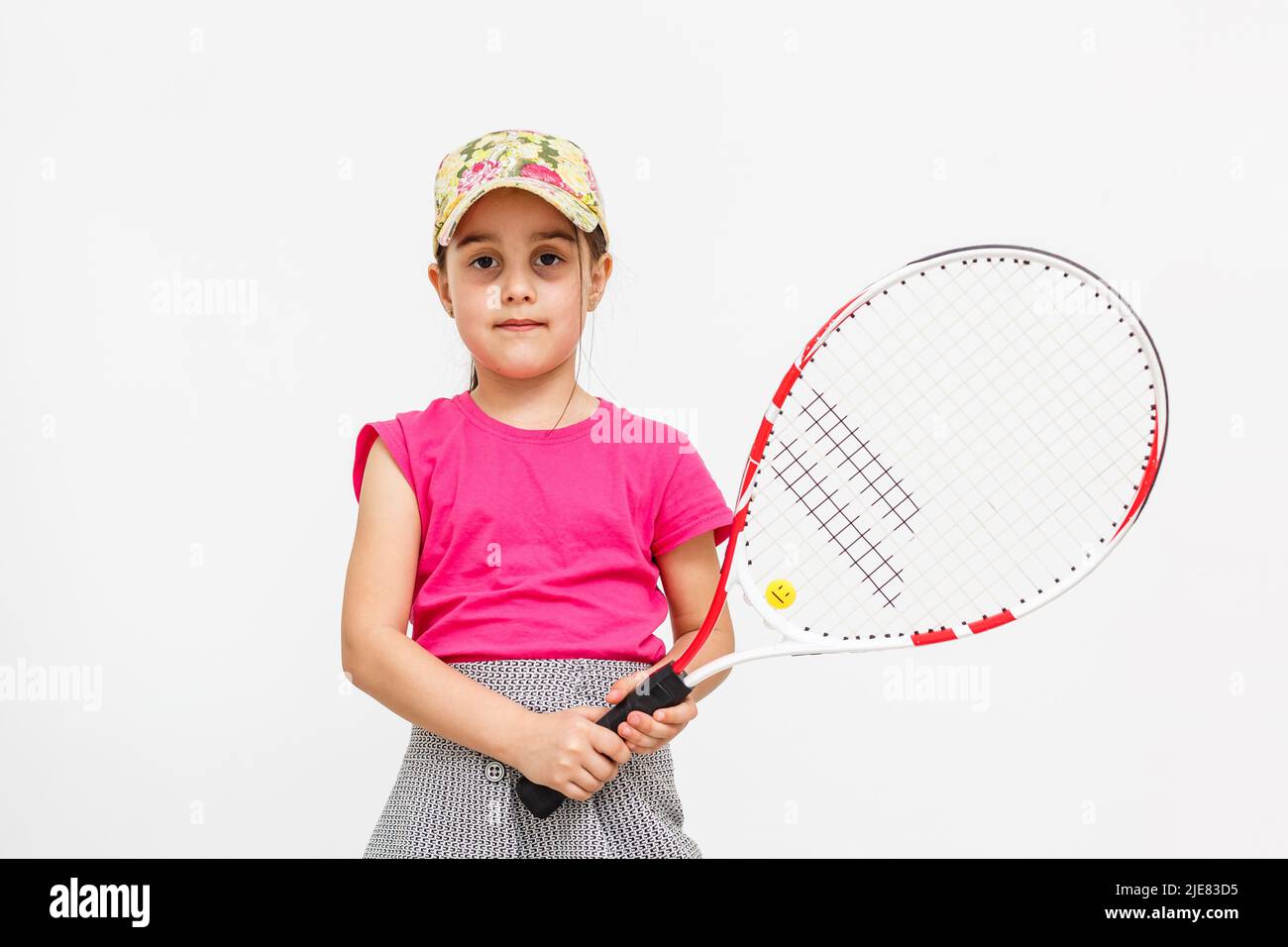 Little Tennis Rackets Cute little girl with tennis racket on white background Stock Photo - Alamy