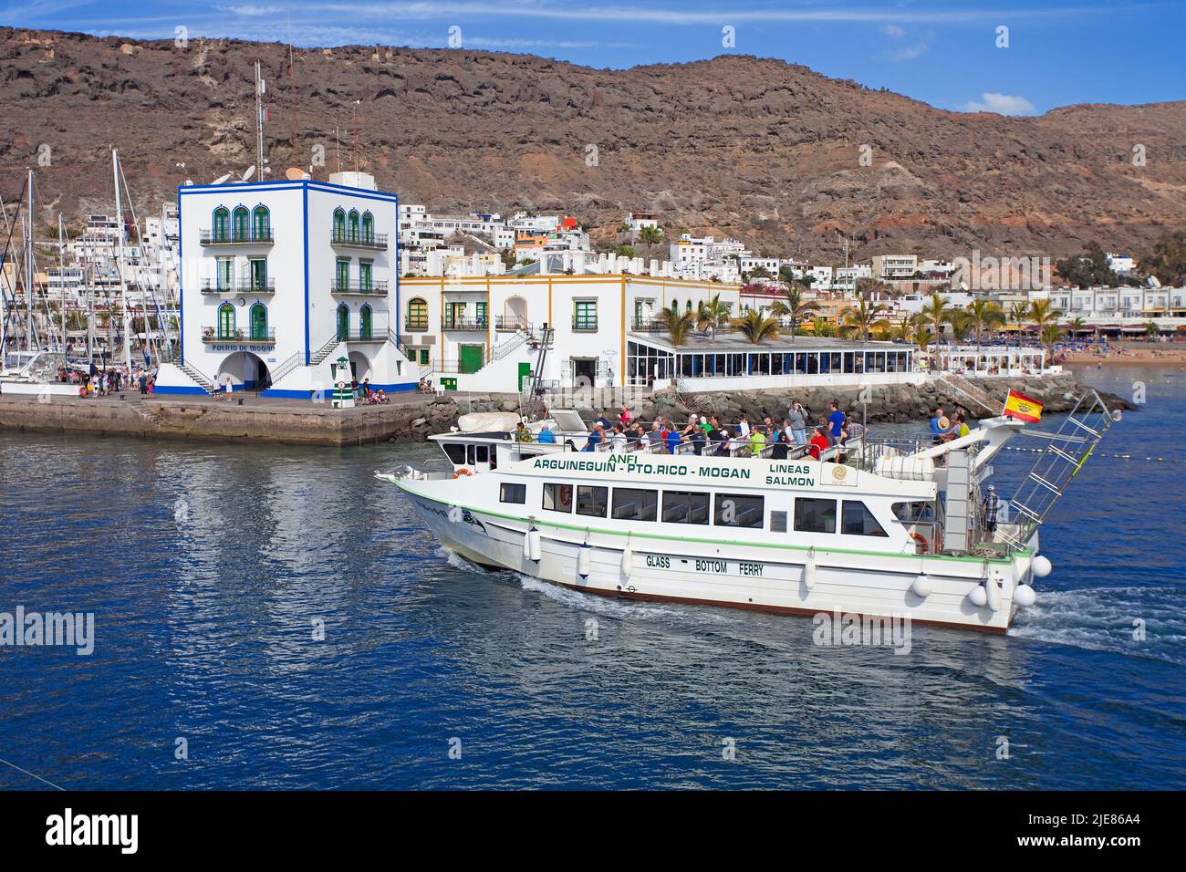Sightseeing, tourist boat at the harbour entrance of Puerto de Mogan, Grand Canary, Canary islands, Spain, Europe Stock Photo