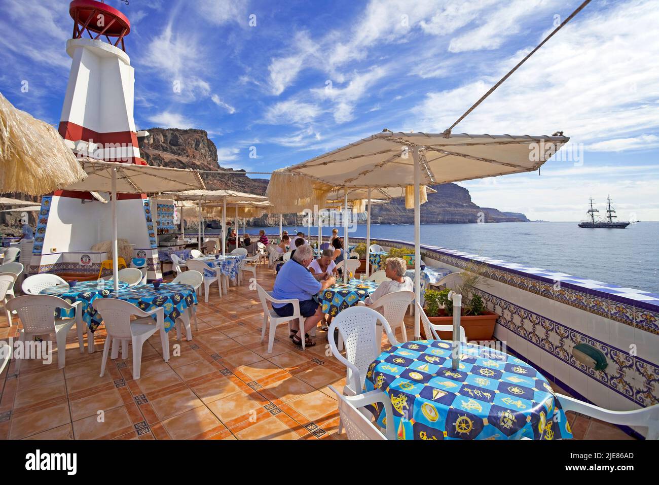 View from the restaurant at lighthouse on the Atlantic Ocean, harbour entrance at Puerto de Mogan, Grand Canary, Canary islands, Spain, Europe Stock Photo