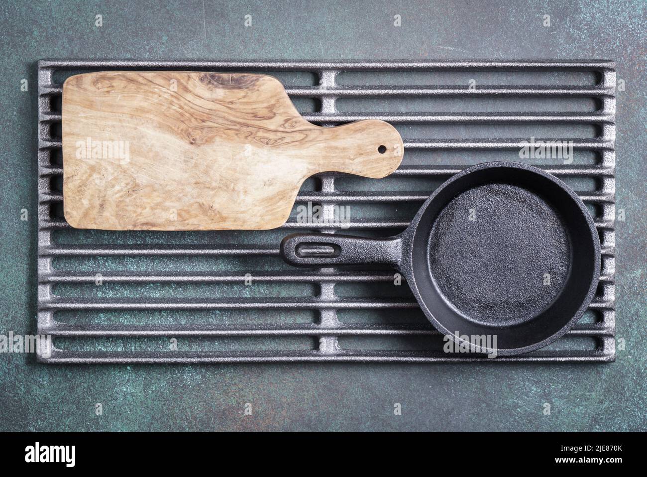 Food background with cutting board and cast iron panon grill grate with copy space Stock Photo