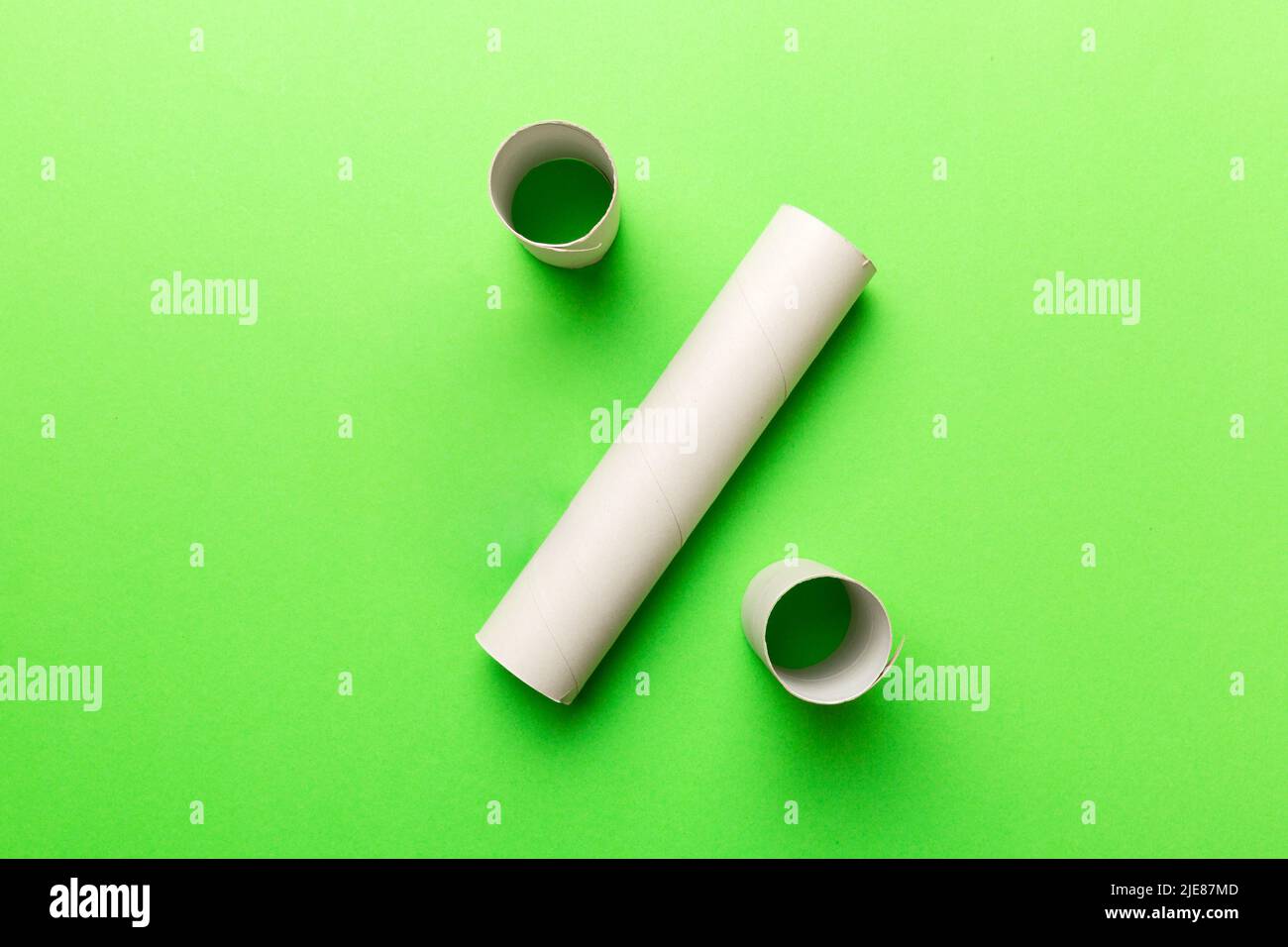 Empty toilet paper roll on colored background. Recyclable paper tube