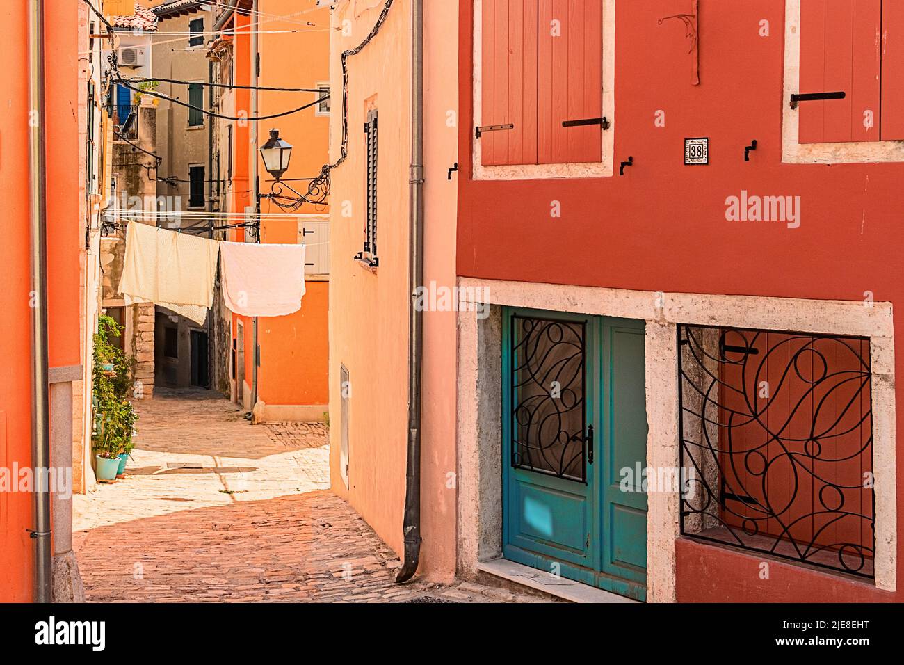 One of the small alleys in the old, colorful Mediterranean town of Rovinj, Croatia. Stock Photo