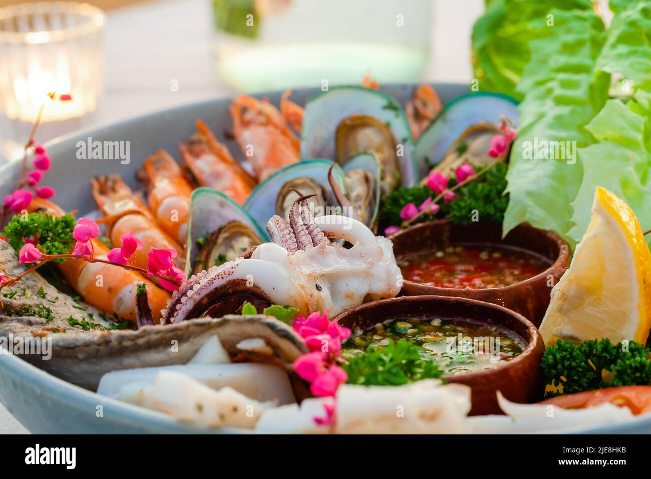 Seafood plate in luxury restaurant. Dinner with cooked shrimps, octopus