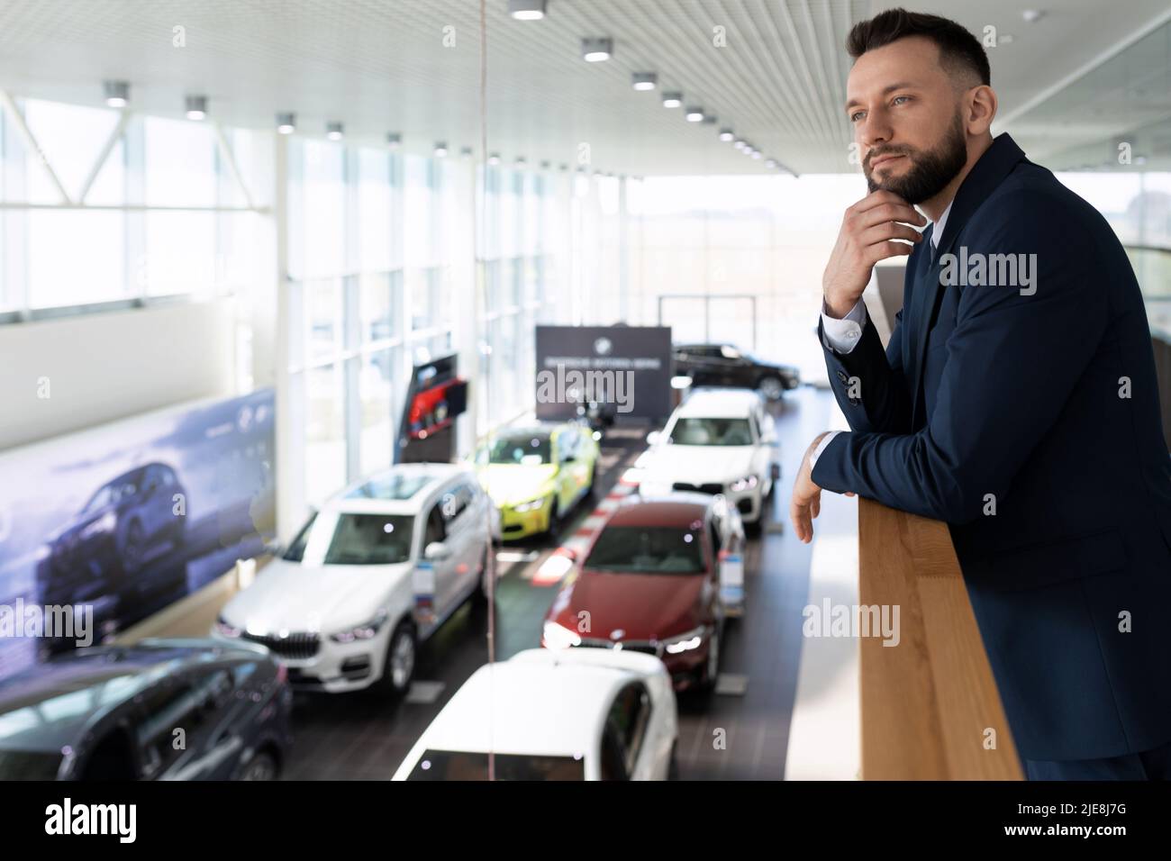 car dealership owner looking down at his cars Stock Photo Alamy