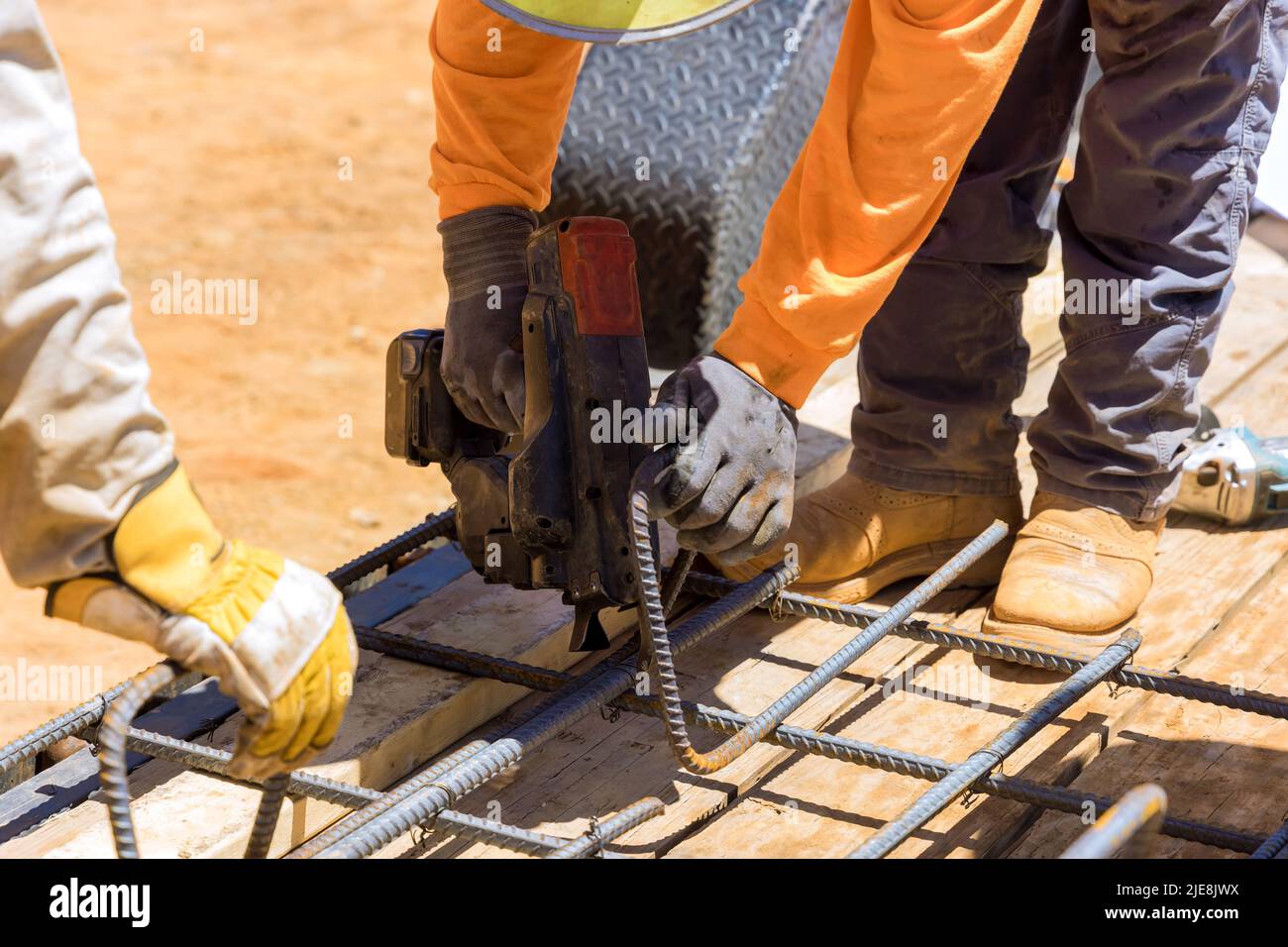 To reinforce cement foundations with steel bars and wire rods, construction workers use a rebar