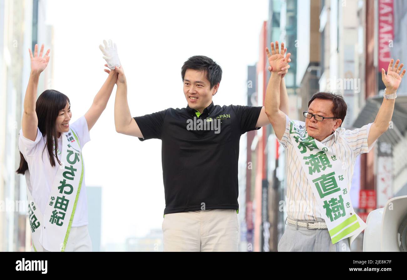 Tokyo, Japan. 26th June, 2022. Osaka Governor and deputy leader of opposition Japan Innovation Party Hirofumi Yoshimura (C) raises arms of his party candidates Yuki Ebisawa (L) and Naoki Inose (R) fortheir campaign of the July 10 Upper House election in Tokyo on Sunday, June 26, 2022. Credit: Yoshio Tsunoda/AFLO/Alamy Live News Stock Photo